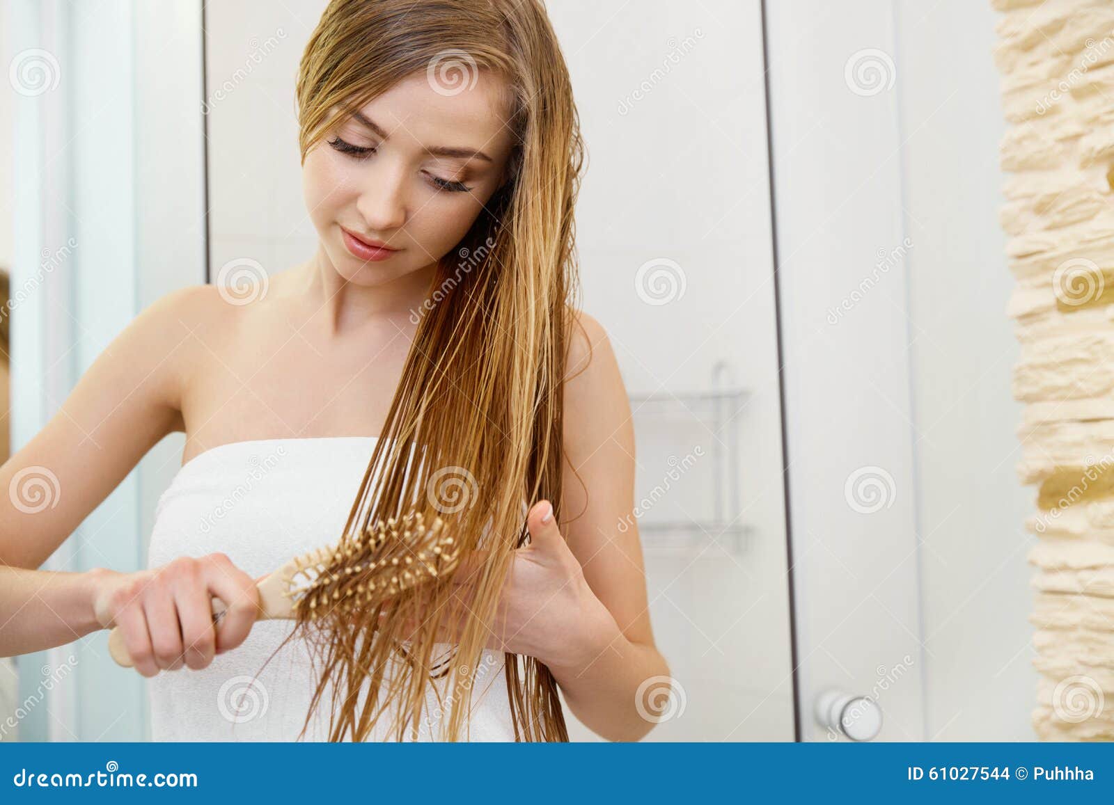 hair. beautiful blond brushing her wet hair. hair care. spa beau