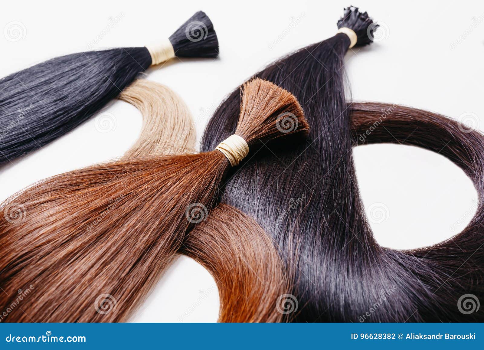 hair extensions of three colors on a white background. copyspace selective focus