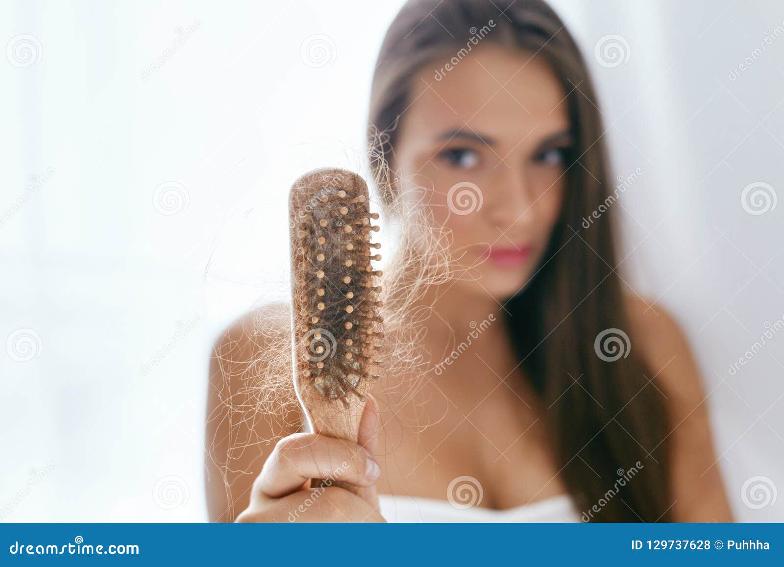 hair loss. upset woman holding brush with hair