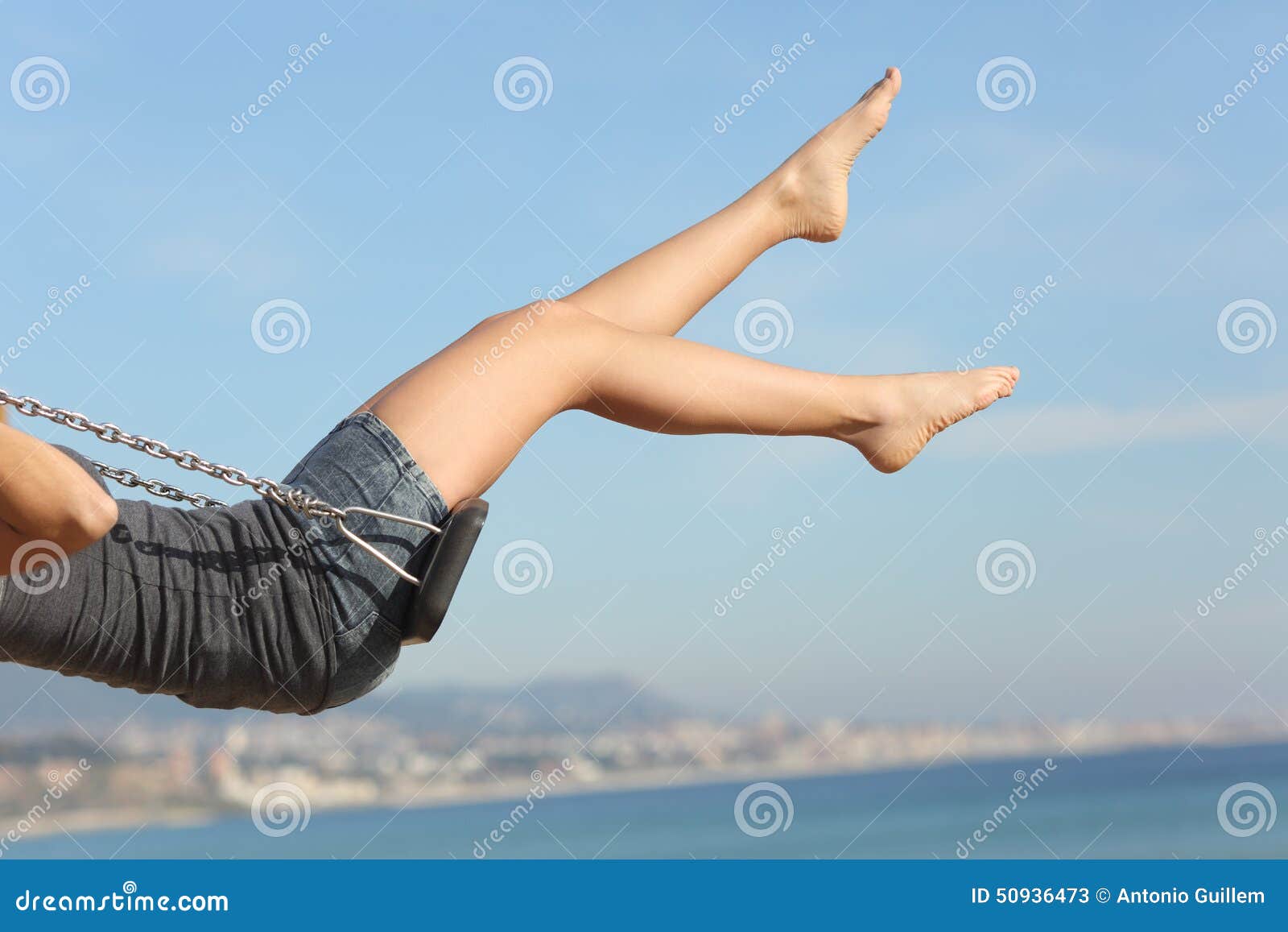 hair removed woman legs swinging on the beach