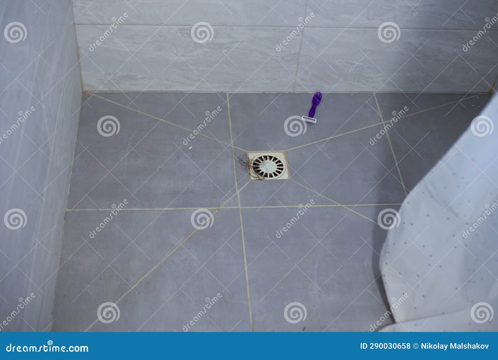 Hair in the Shower Sink and Razor on the Floor. Clogged Sink after Hair