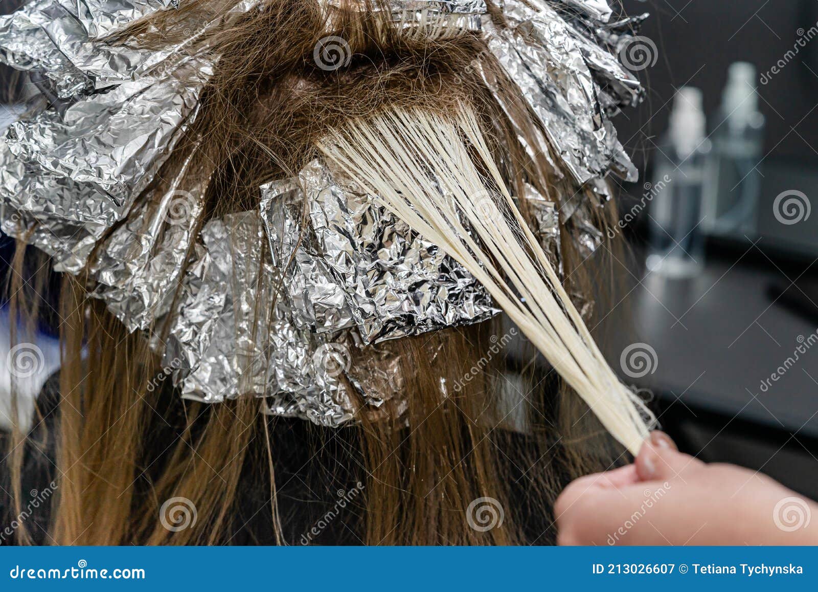 Hair Stylist Checking Models Hair during Bleaching Process. Trendy Hair