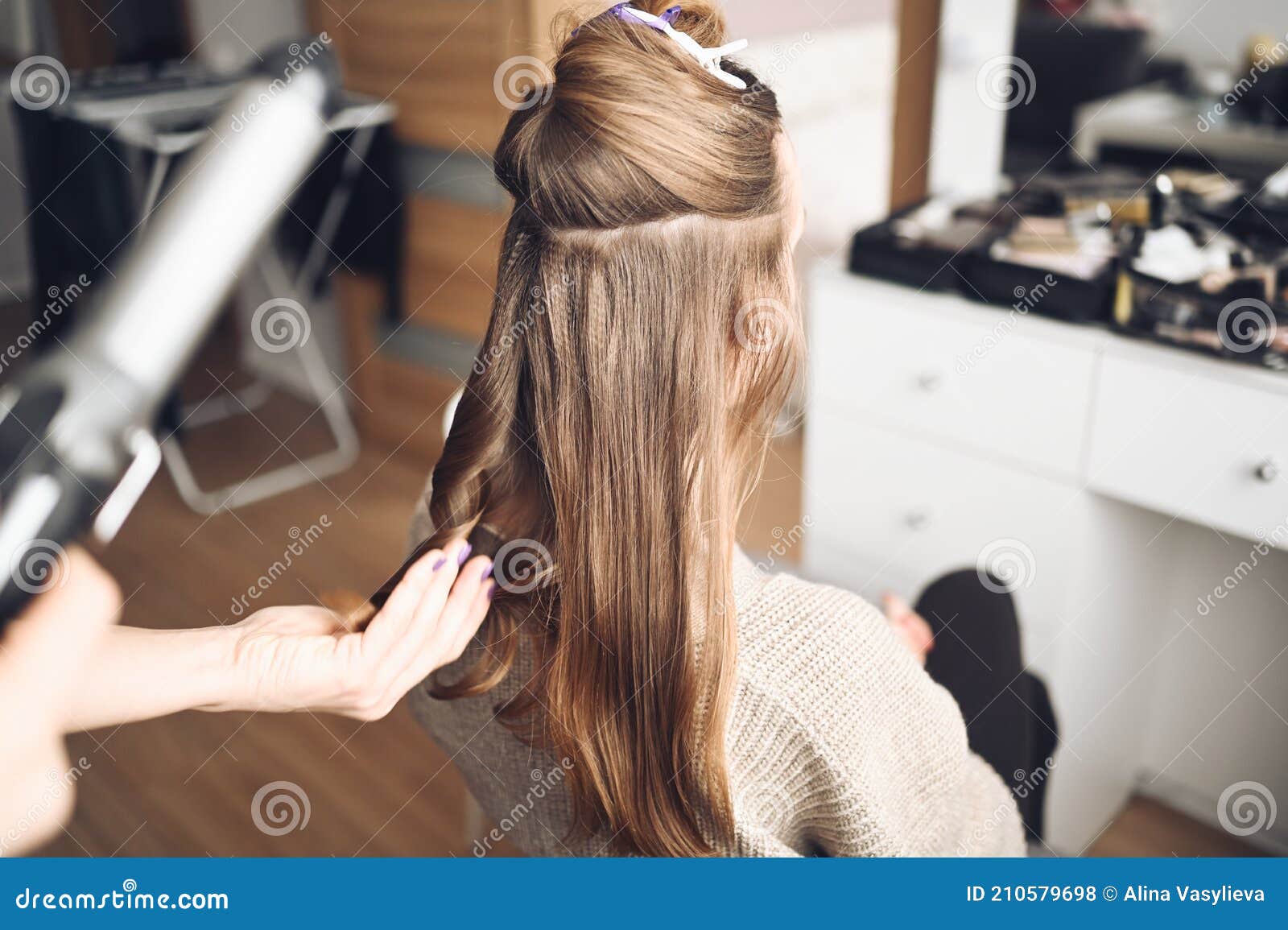 Hair Stylist Prepares Beautiful Young Woman for Event, Makes Curls Hairstyle  with a Curling Iron for Client in Beauty Salon. Long Stock Photo - Image of  glance, hairdressing: 210579698