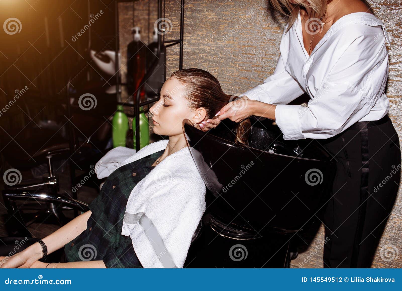 Hairstylist Washing Hair To The Customer Before Doing Hairstyle