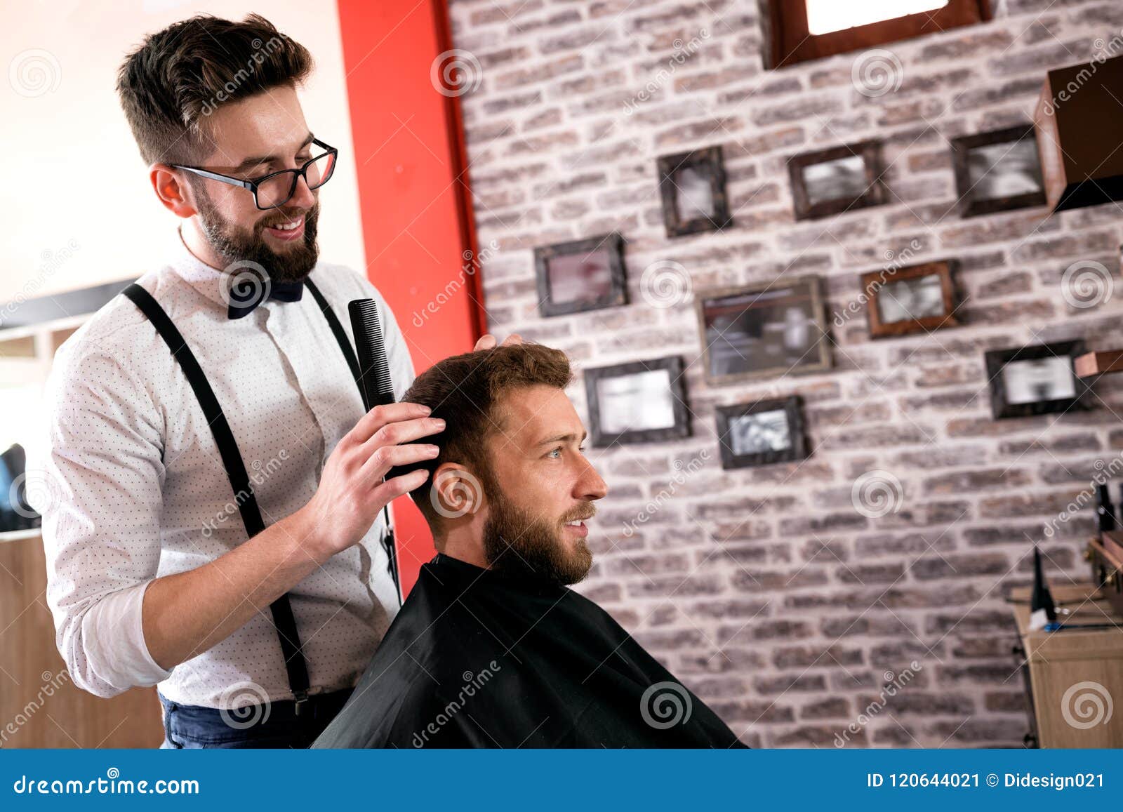 hairdresser adjusts hair a customer with a comb