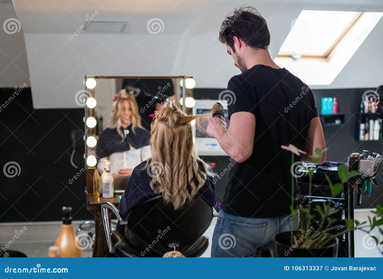 hairdresser and blonde cliente at salon