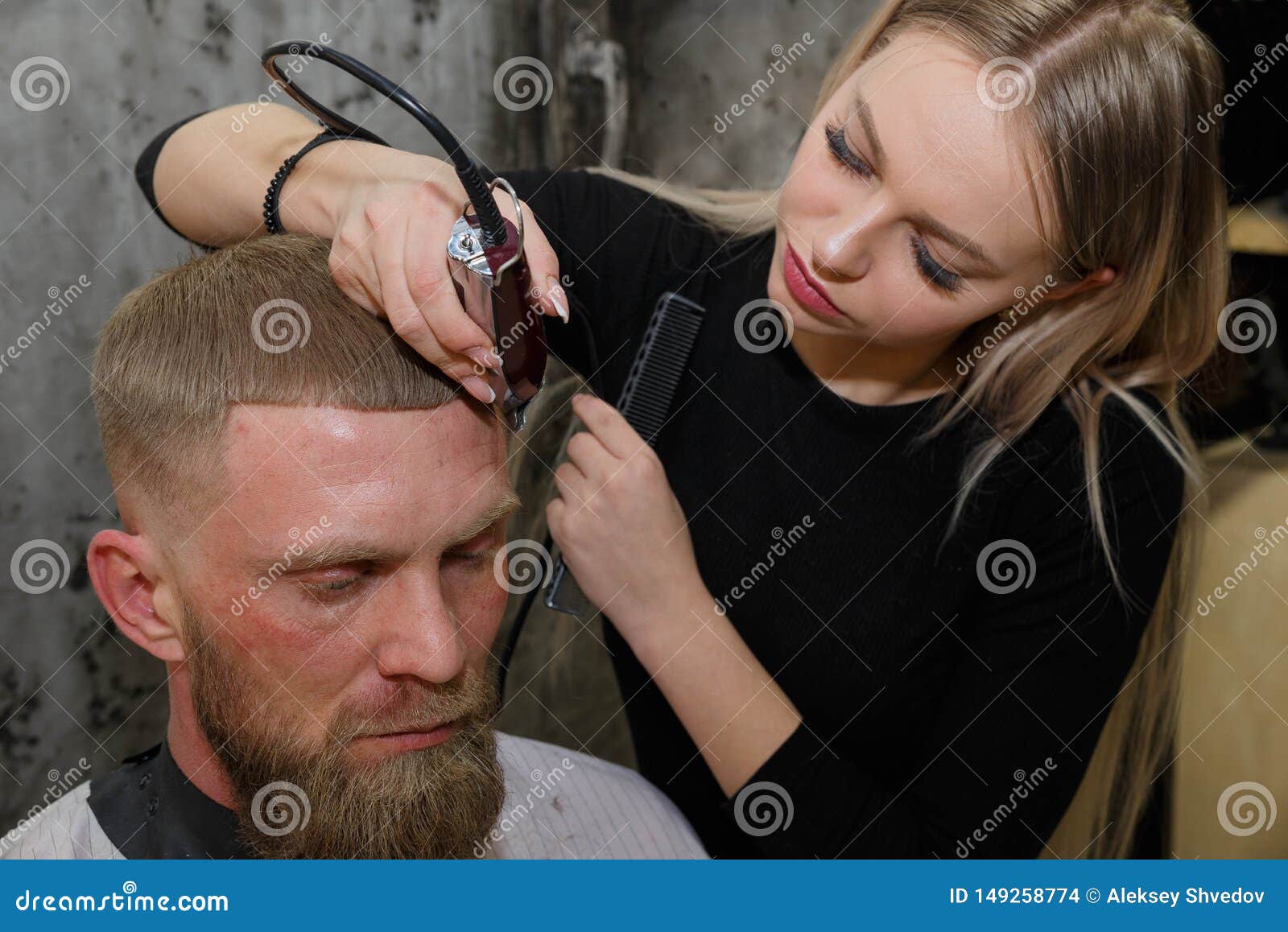 Hairdresser Cuts Machine Man Closeup In A Barbershop Stock Photo