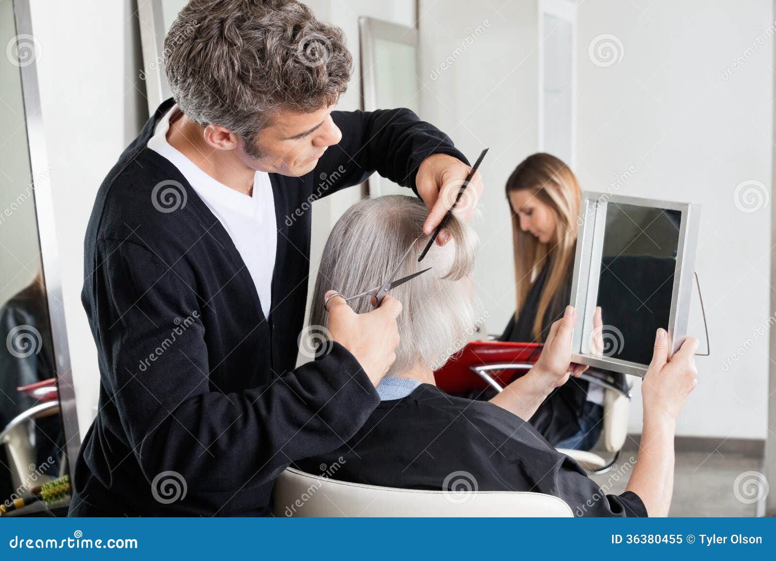 Hairdresser Cutting Client's Hair At Salon Stock Image 