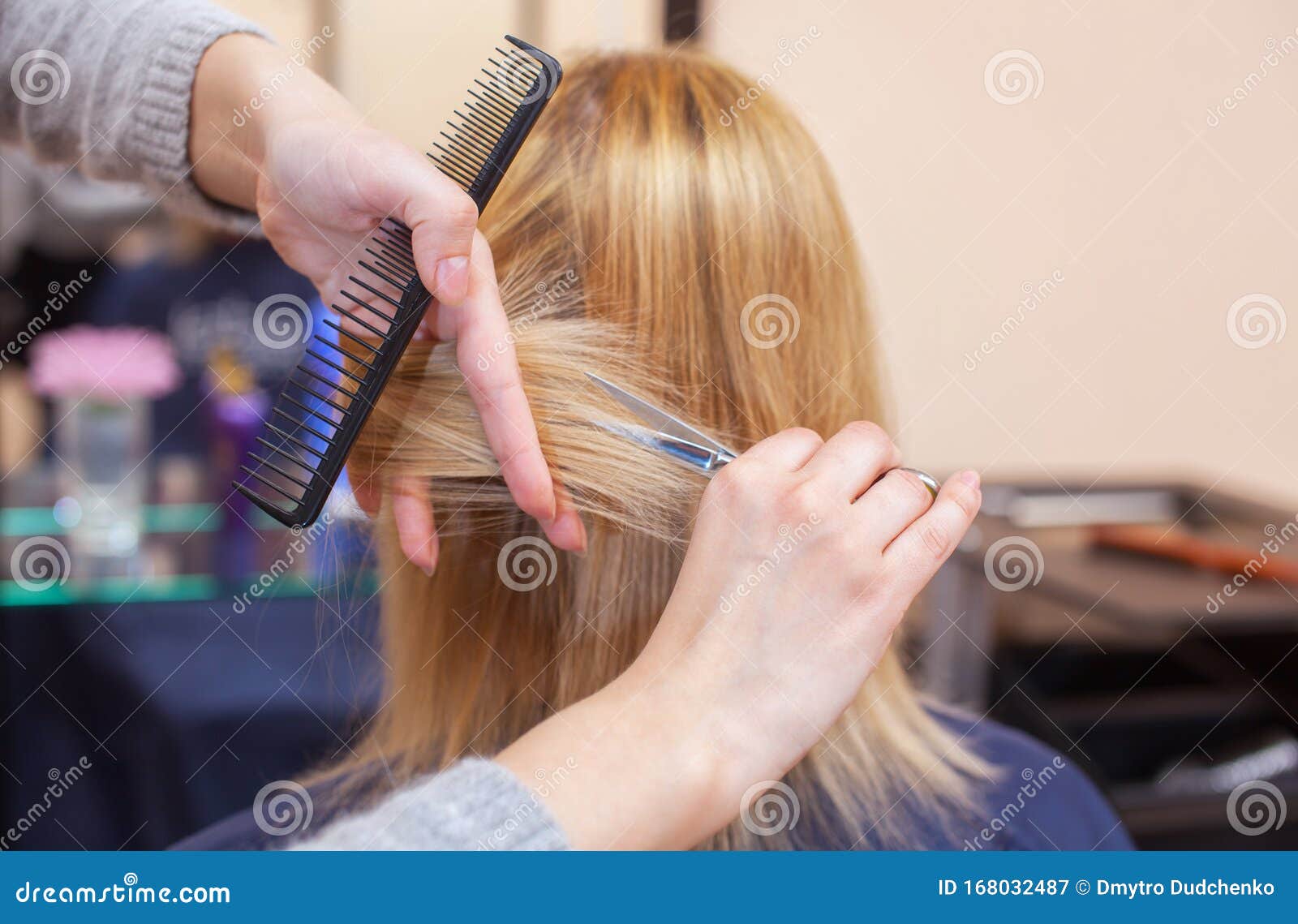 The Hairdresser Does A Haircut With Scissors Of Hair To A ...