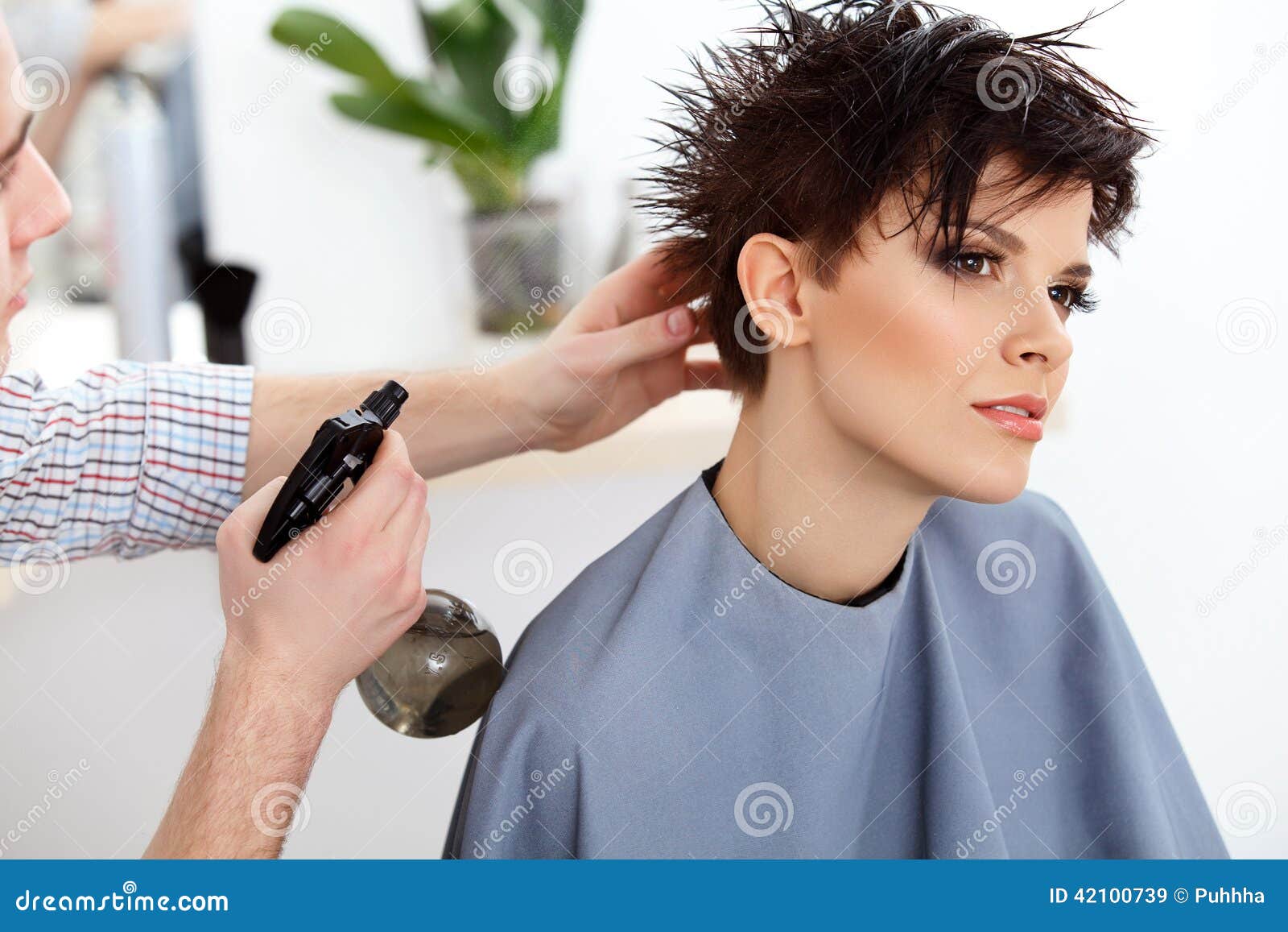 Hairdresser Doing Hairstyle. Brunette With Short Hair In 