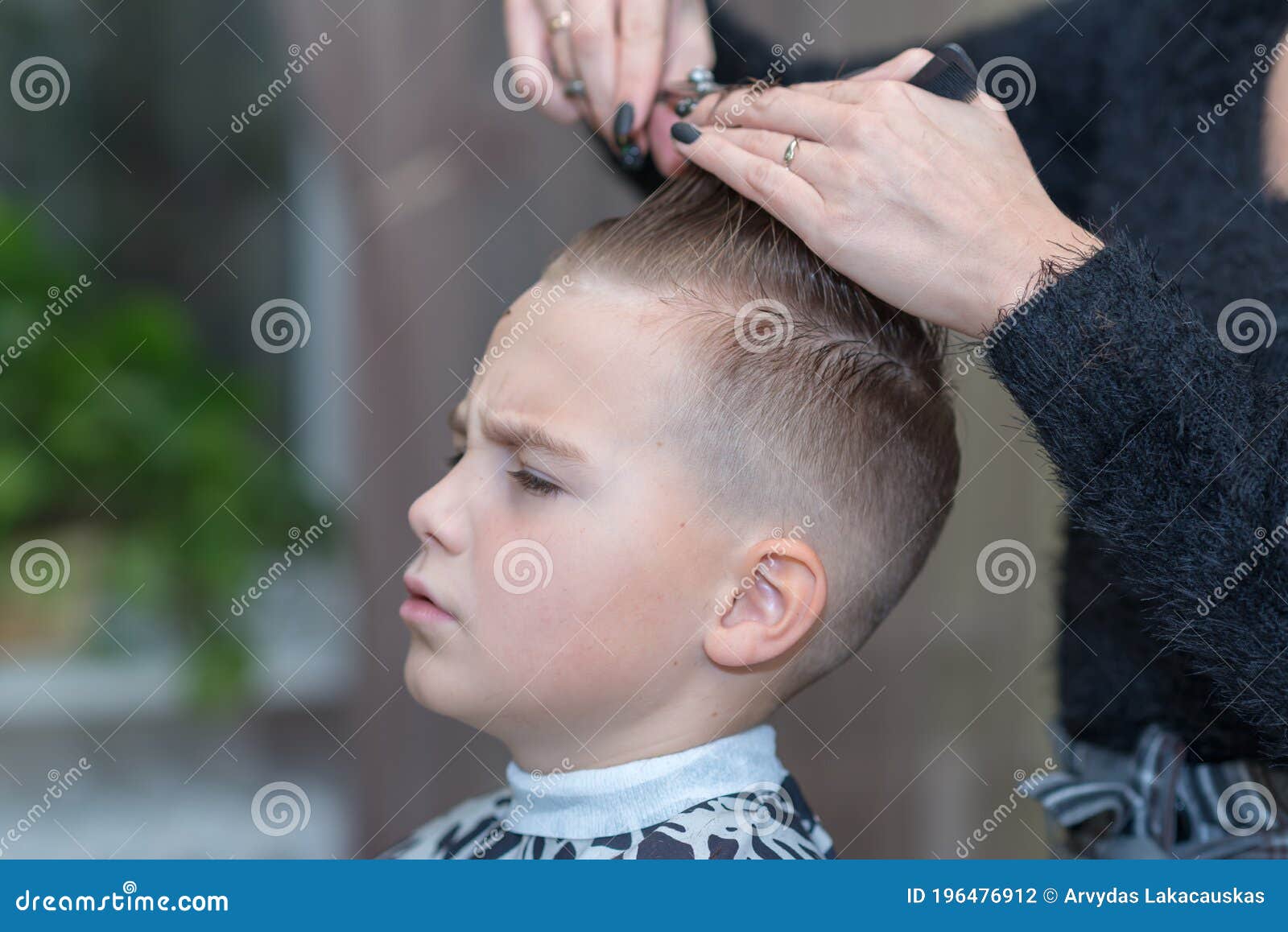 Side View Hairdresser Makes a Stylish Hairstyle. the Woman is Standing and  Making Haircut for Blonde Boy Stock Photo - Image of care, client: 196476912