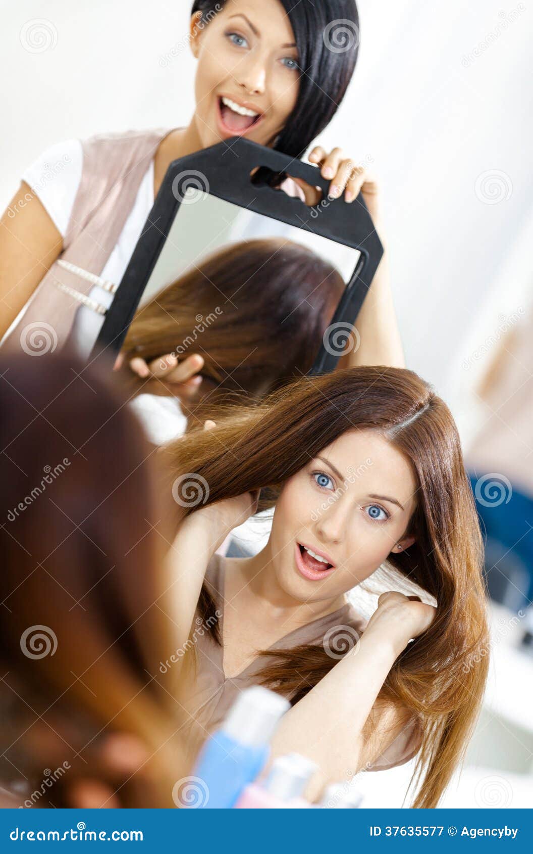 Hairdresser Showing the Hairstyle of Client in Mirror Stock Image