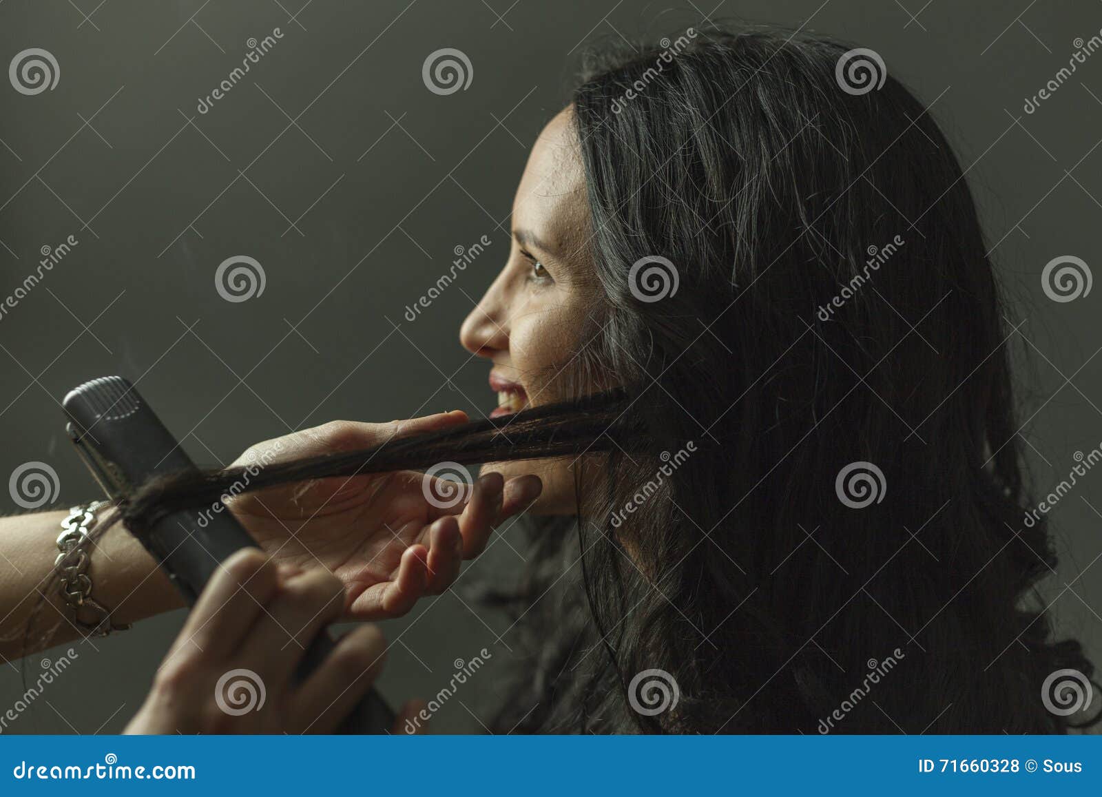 hairdresser straighten womans hair in a set