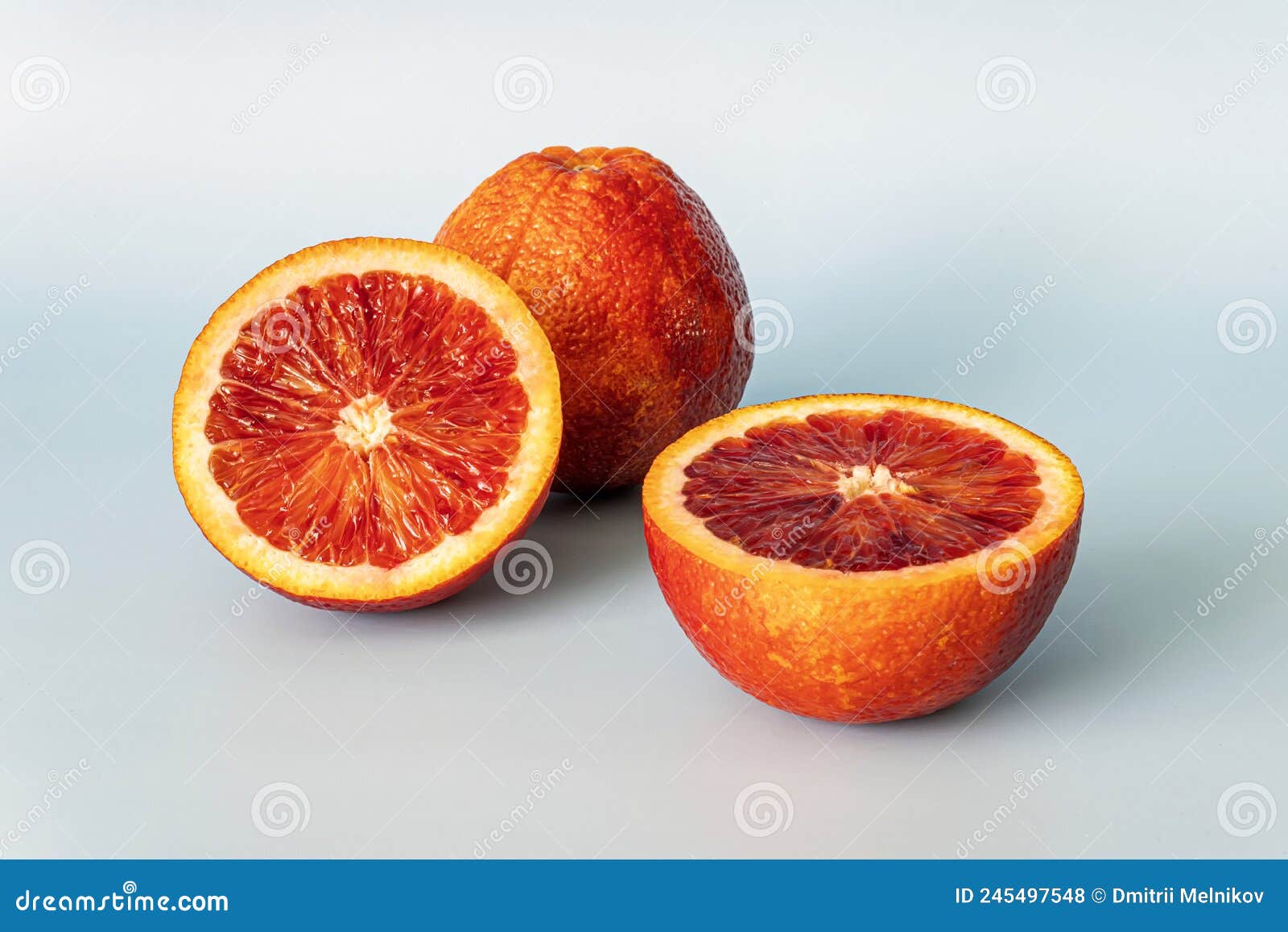 Half of Blood Red Orange Citrus Fruit on Blue Background. Orange Half