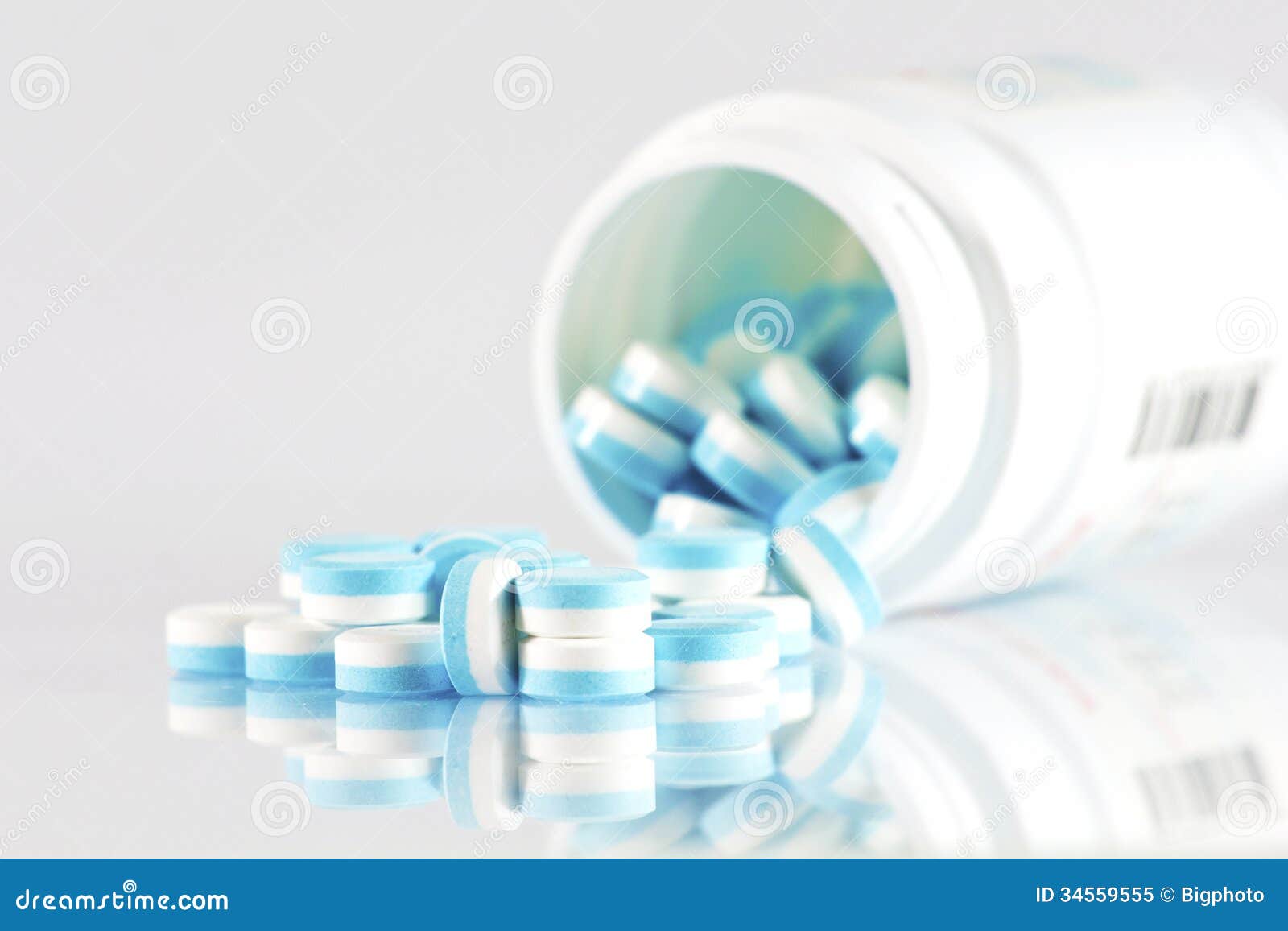 A Half of Blue and White Pills Over White Background Stock Image