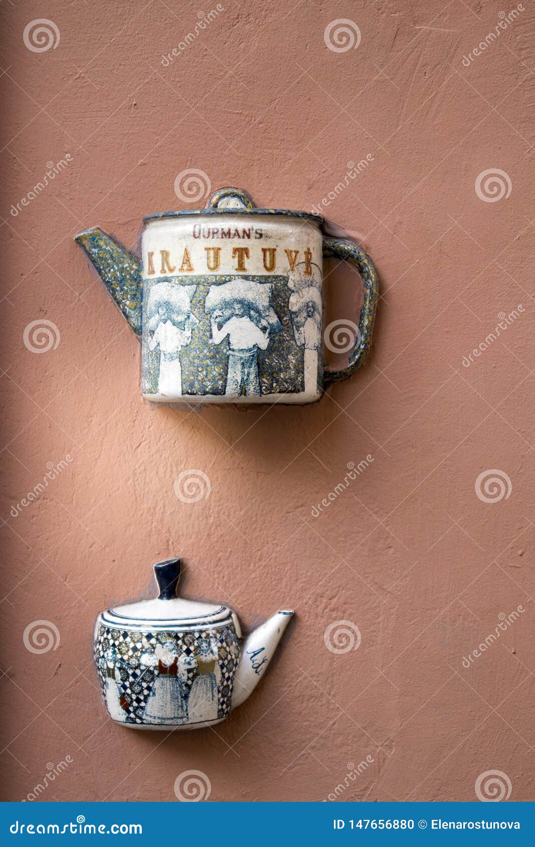 Half Ceramic Teapots Glued on the Wall of House in Vilnius Editorial