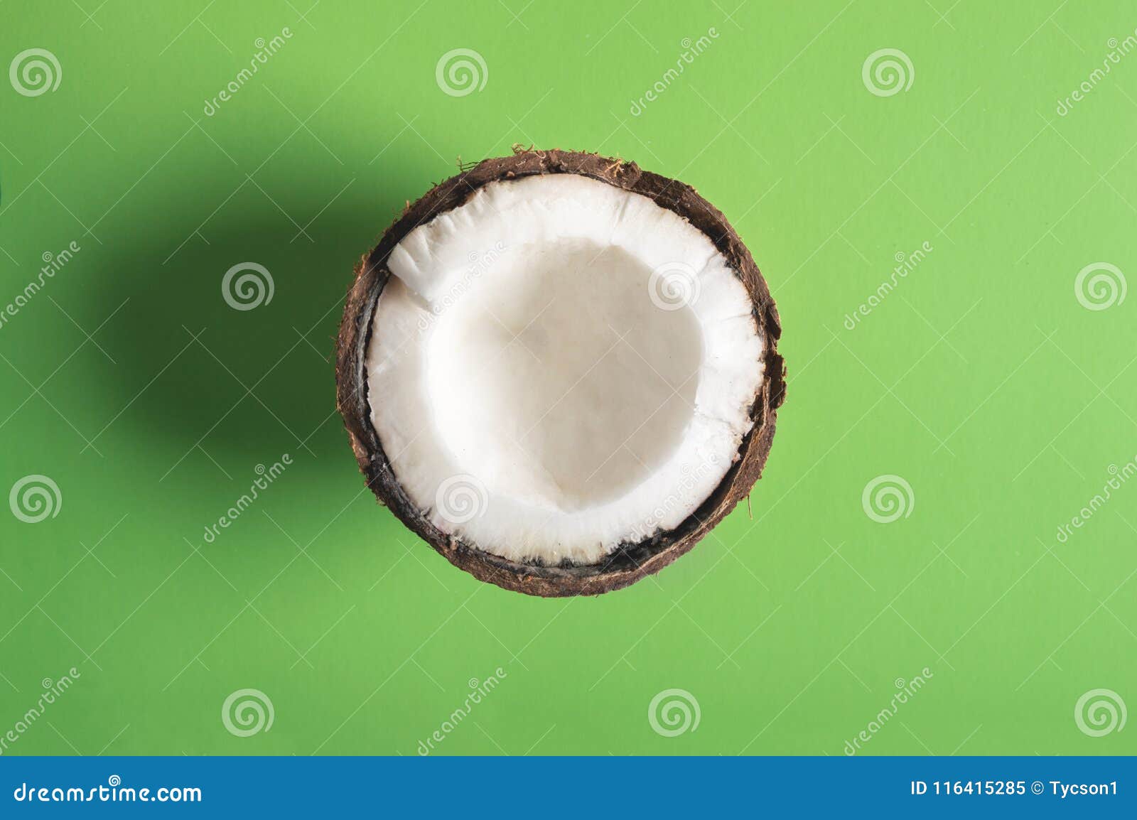 Half of Coconut on a Green Background Stock Image - Image of nutrition