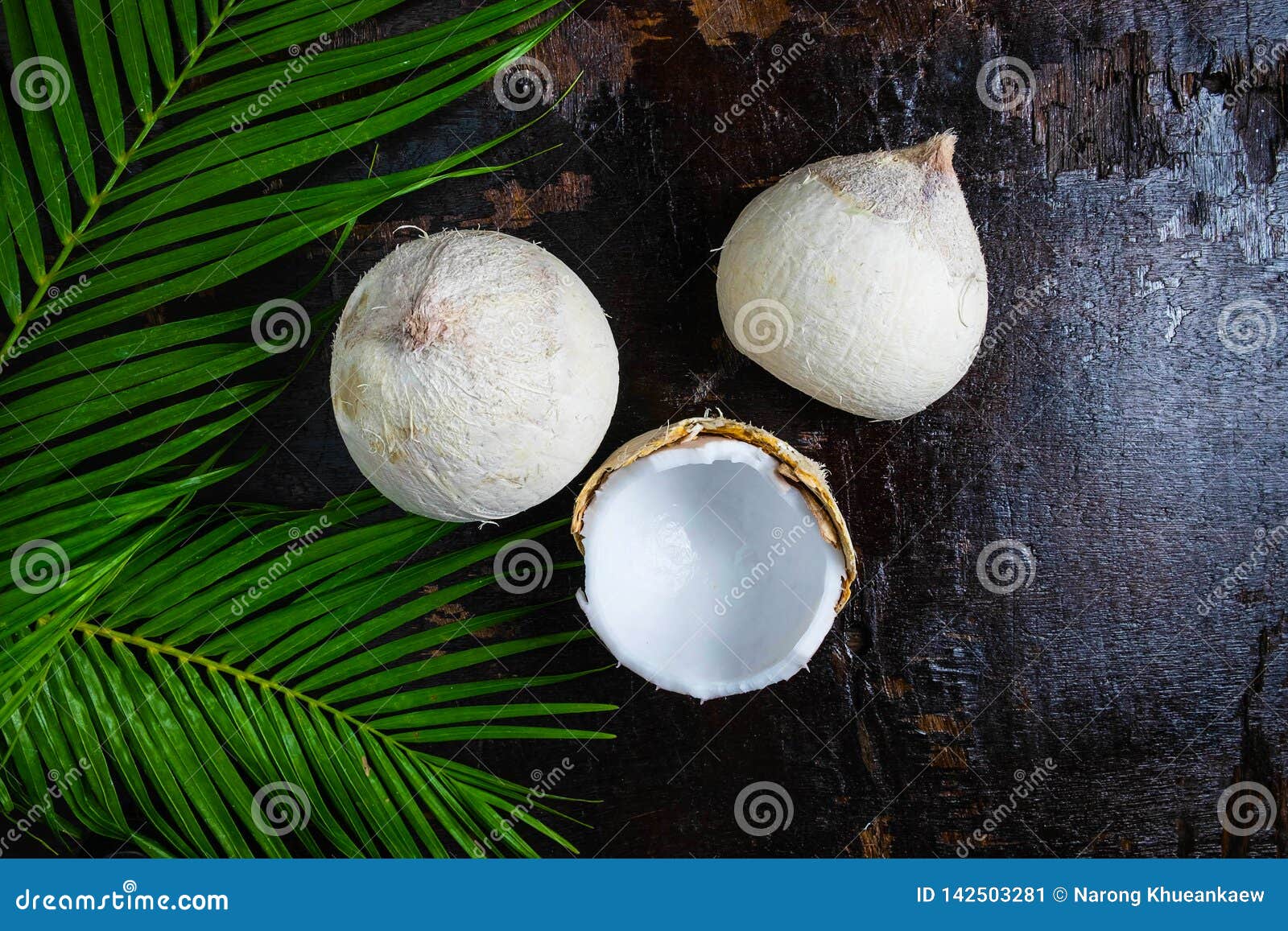 Half of Coconut with Leaves on Wooden Background Stock Image - Image of