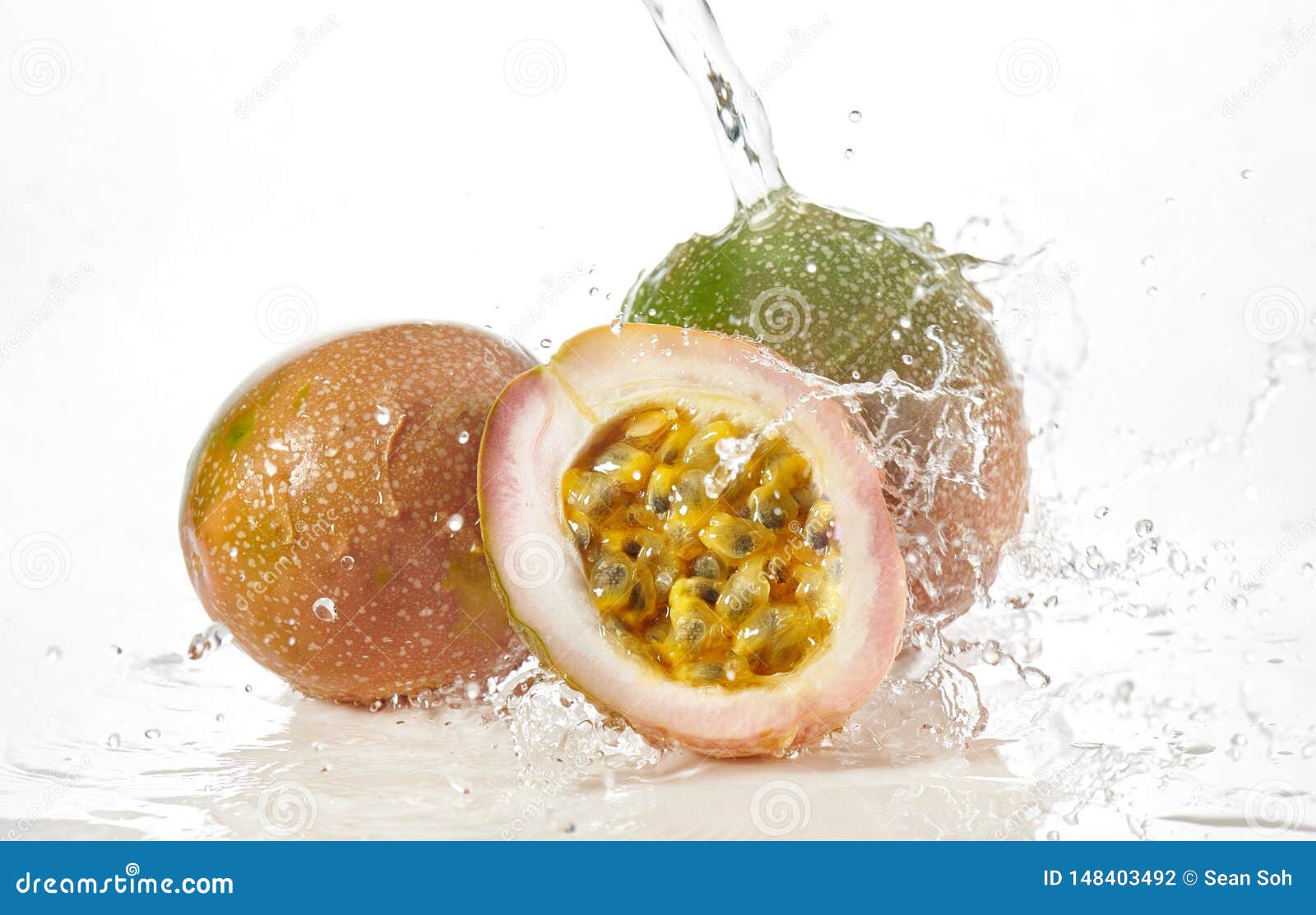 Half Cut Passion Fruit with Water Splash Isolated on White. Stock Photo Image of