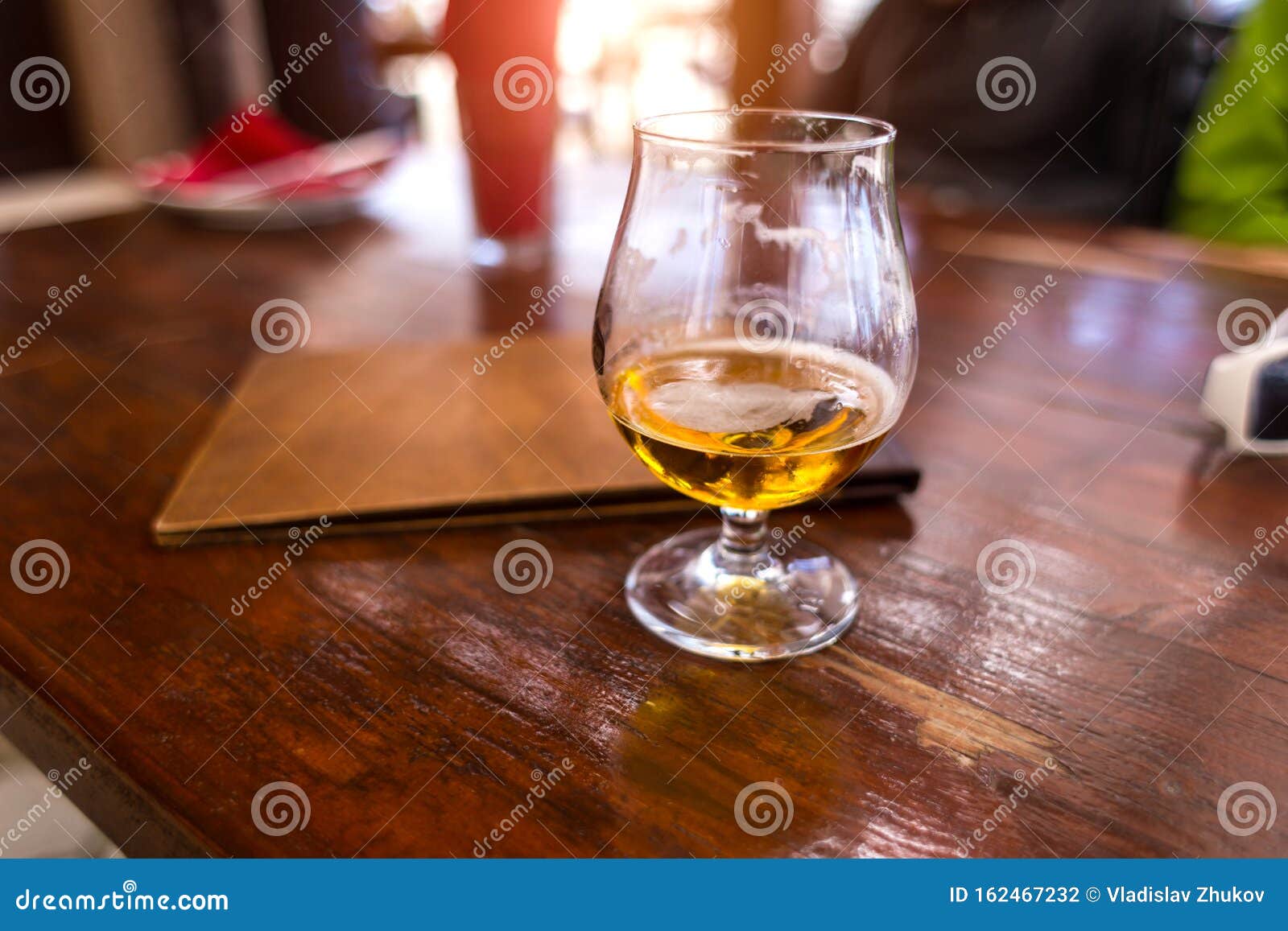 Halfempty Glass with an Alcoholic Drink Stock Photo Image of flow