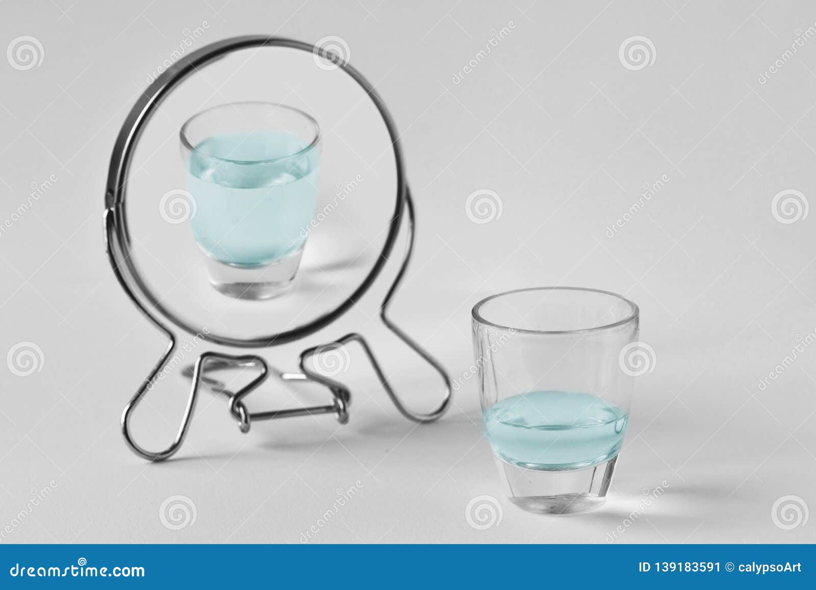 half-empty water glass looking in the mirror and seeing himself as a full glass - concept of optimism
