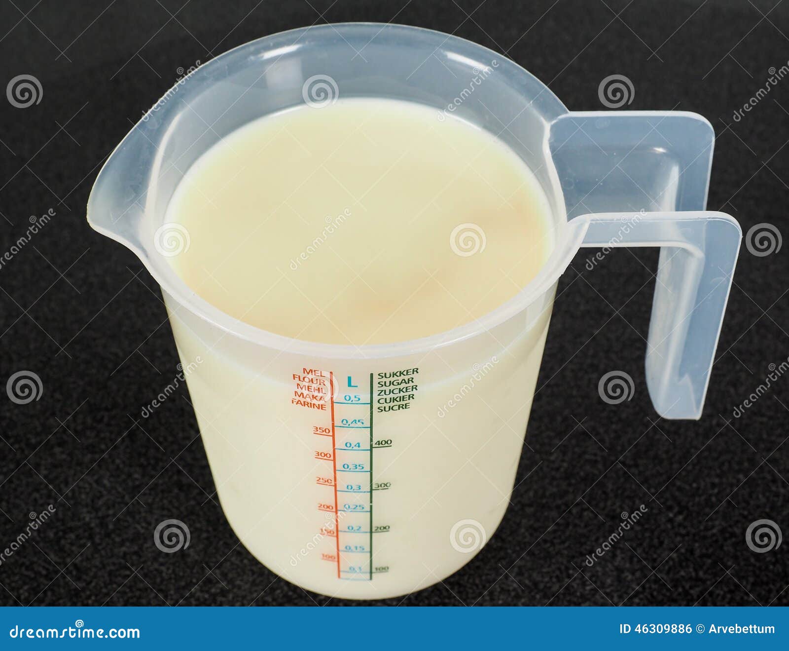 half a liter of white milk in a transparent jug
