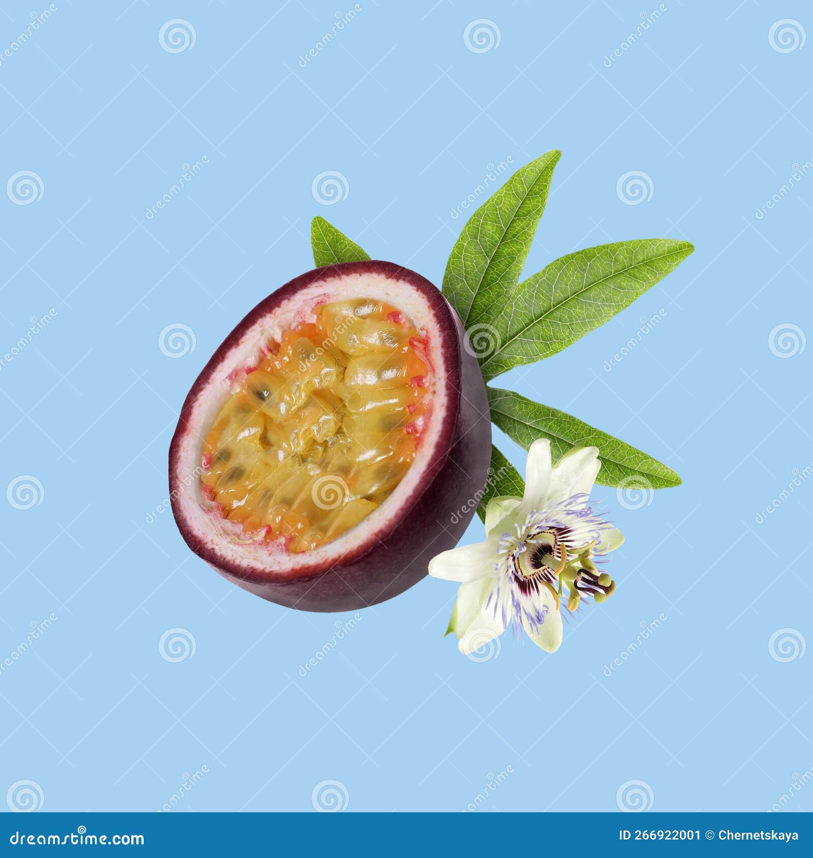 Half of Passion Fruit, Leaf and Passiflora Flower Falling on Light Blue