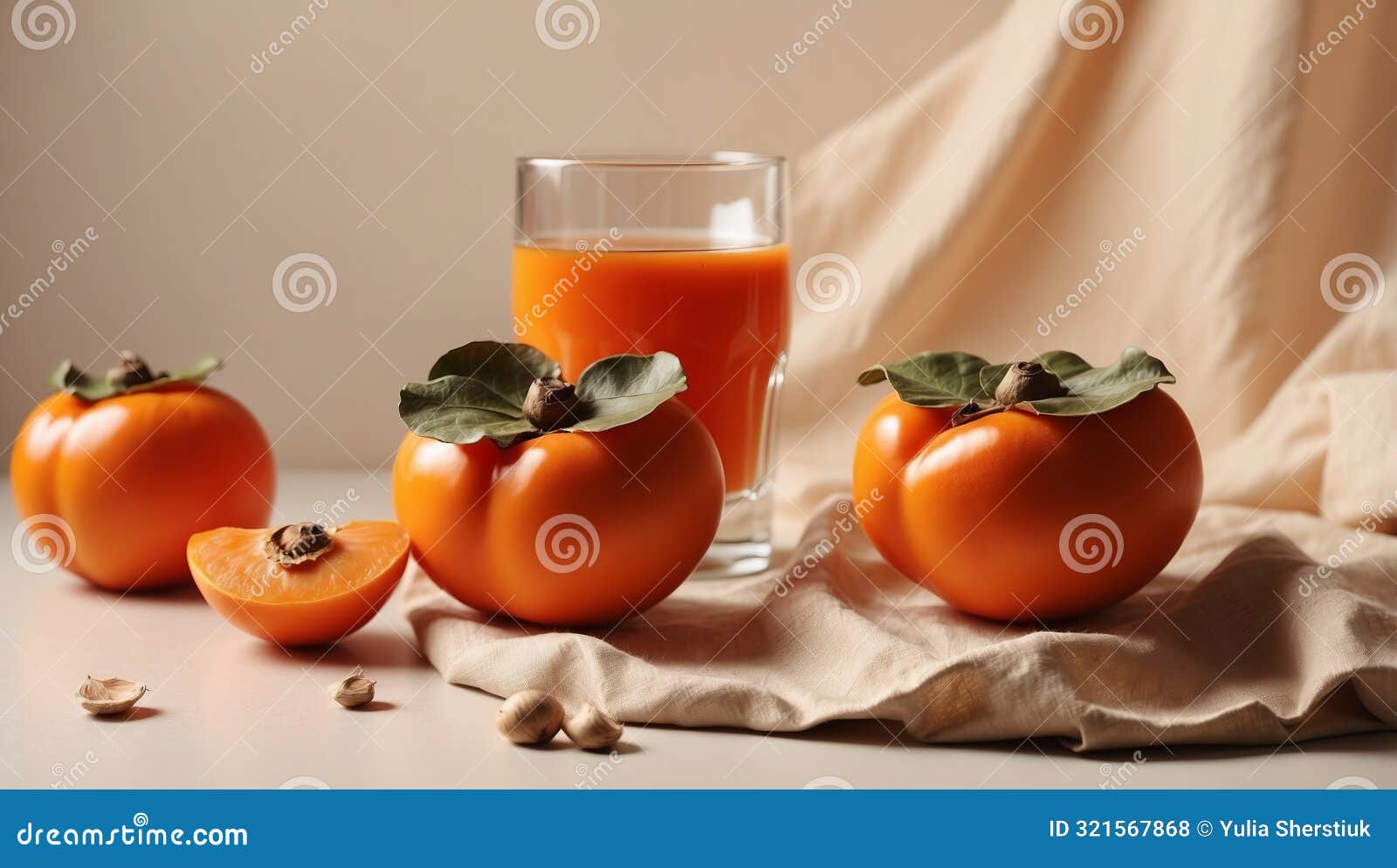 half of persimmon with white cloth and shadows of two glasses on beige pastel background summer refreshment concept
