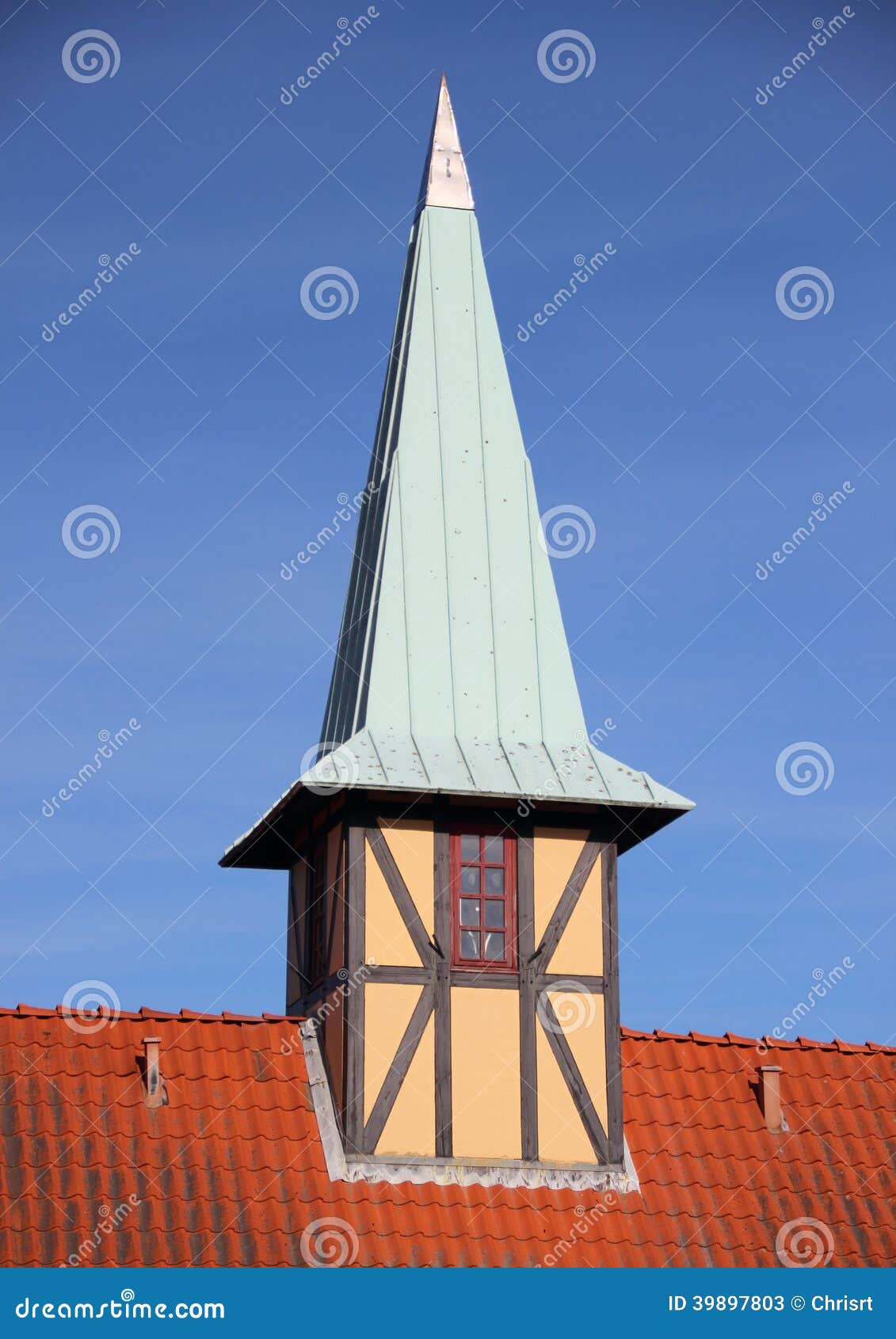 half-timbering tower with verdigris roof on red tile building