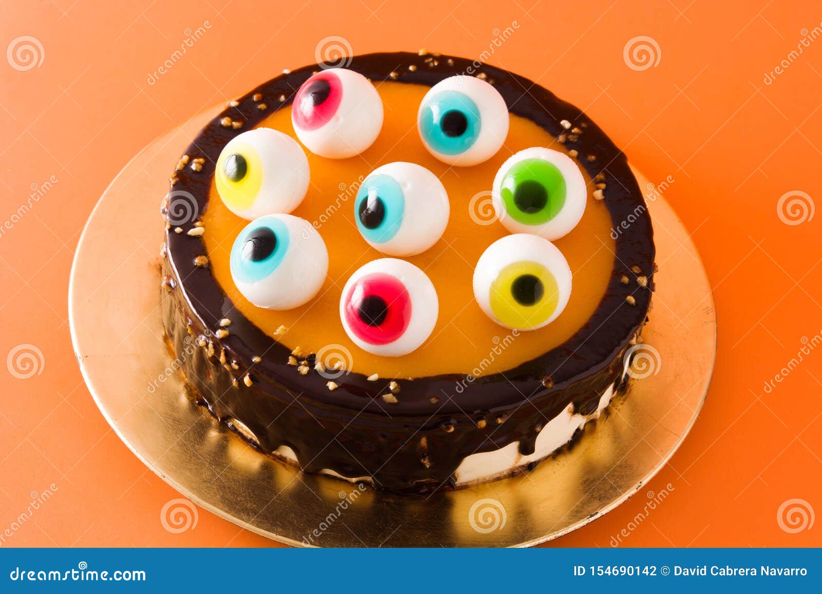 Halloween Cake with Candy Eyes Decoration on Orange Background ...