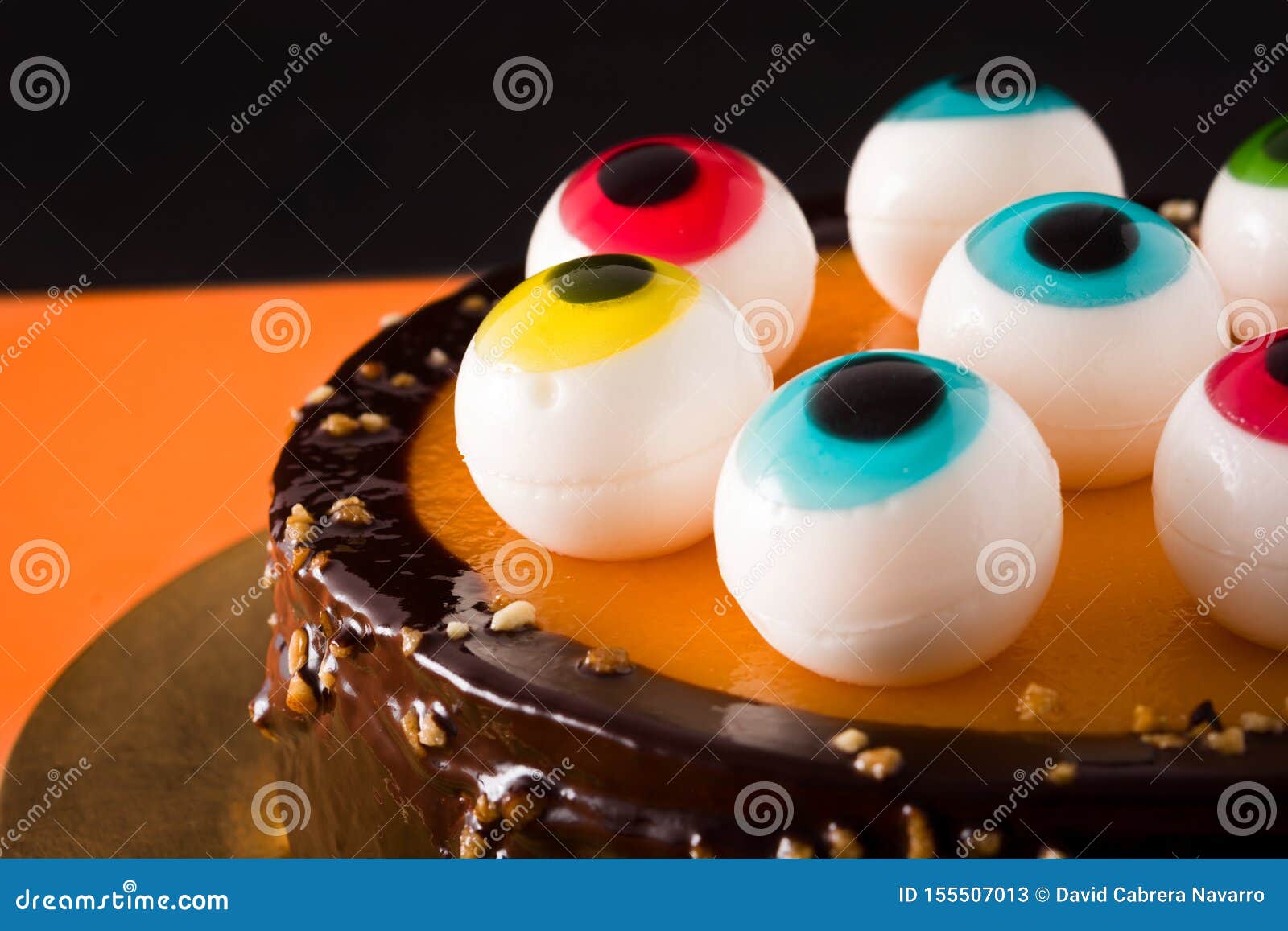 Halloween Cake with Candy Eyes Decoration on Orange and Black