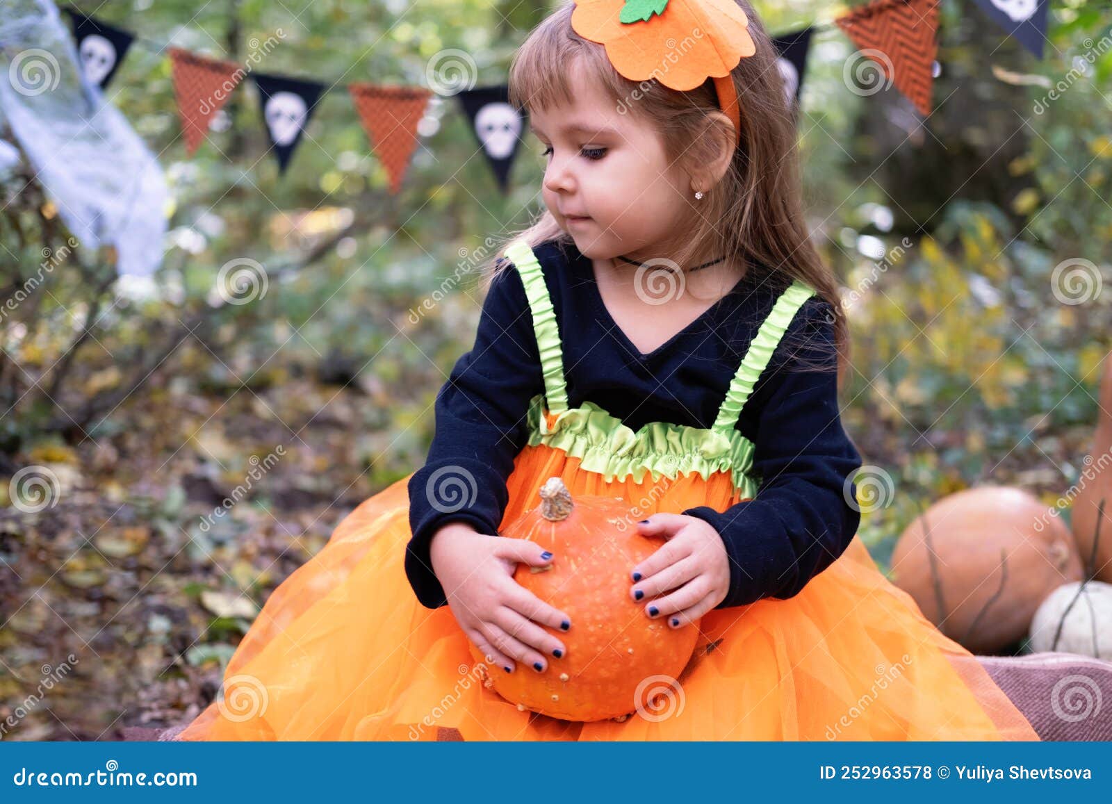 Halloween. Cute Girl in Pumpkin Costume with Pumpkin Outdoor, Having ...