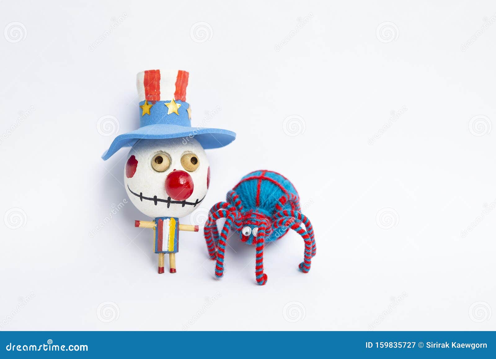 funny bozo ghost and blue yarn spider isolate on white background