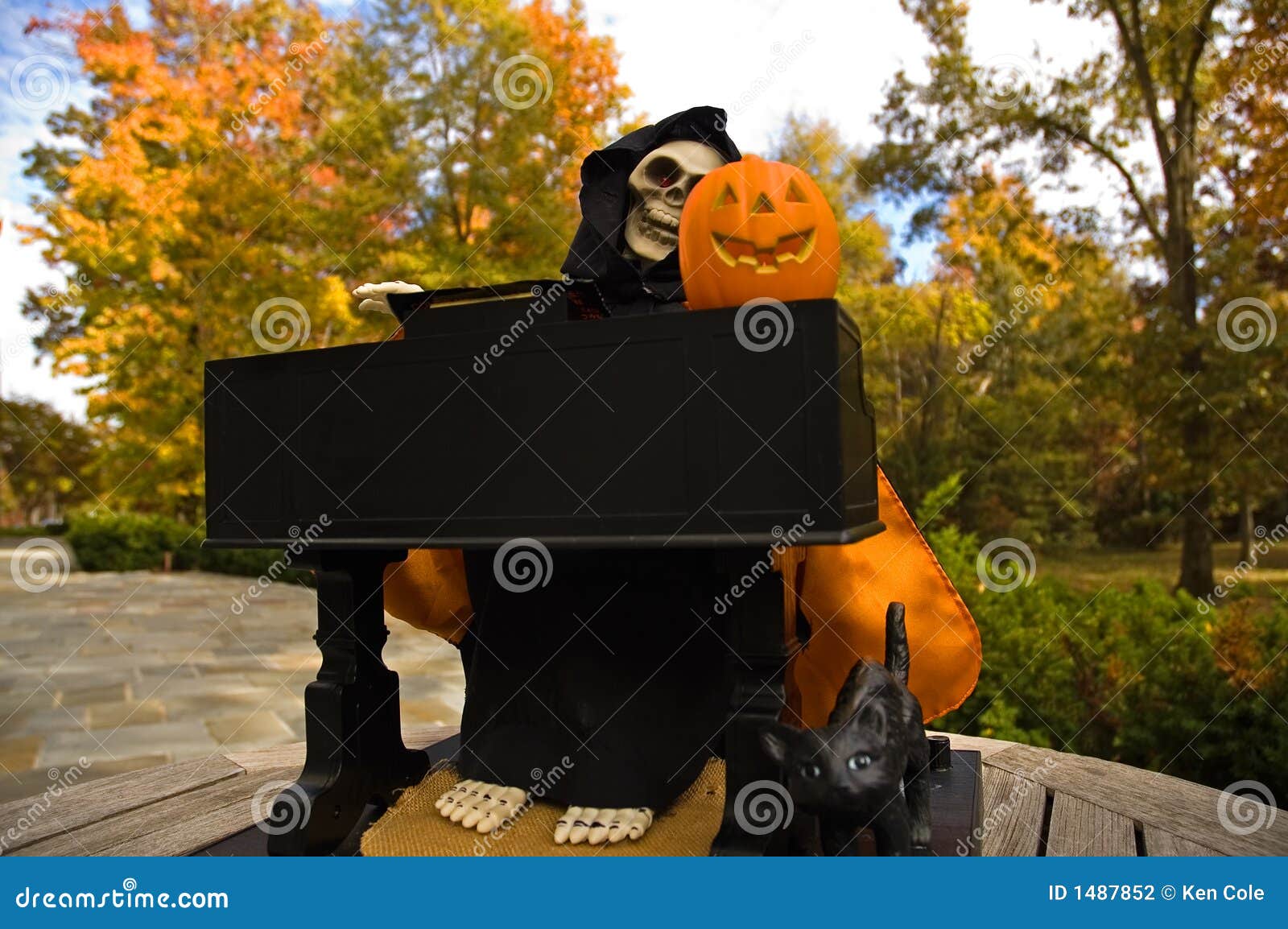 Halloween Ghoul Playing a Piano-2. Scary Halloween figure dressed up as a ghoul, playing a piano with a carved pumpkin on it