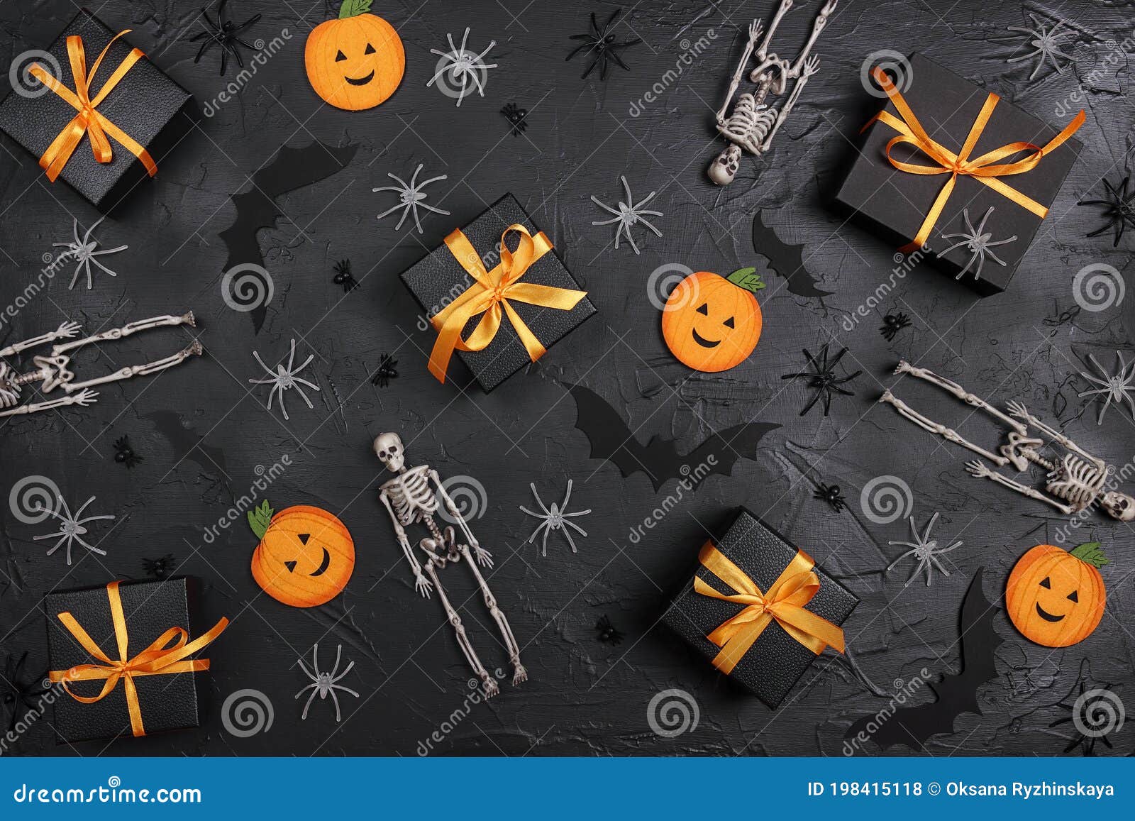 halloween holiday background with gifts and decorations on black backdrop