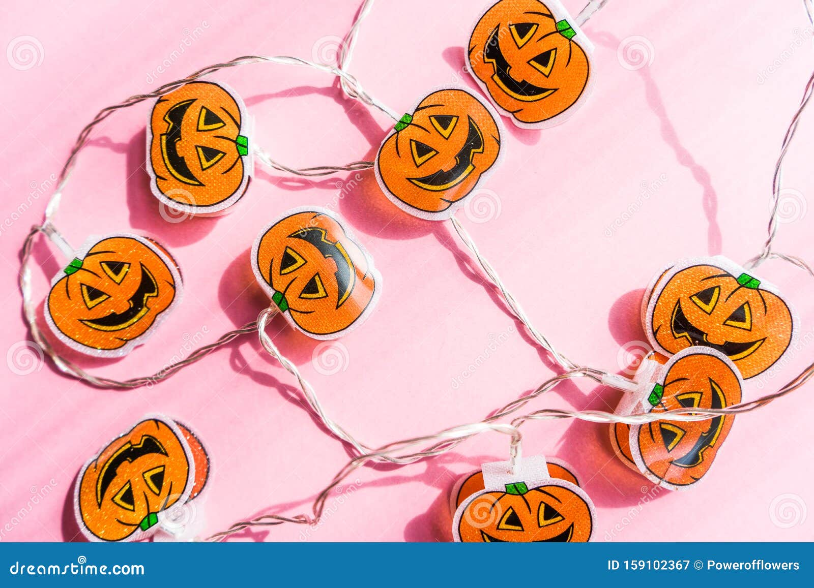 Halloween Pumpkin String Lights on Light Pink Background.Flat Lay Stock