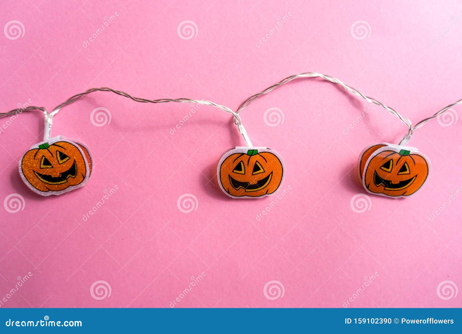 Halloween Pumpkin String Lights on Light Pink Background.Flat Lay Stock