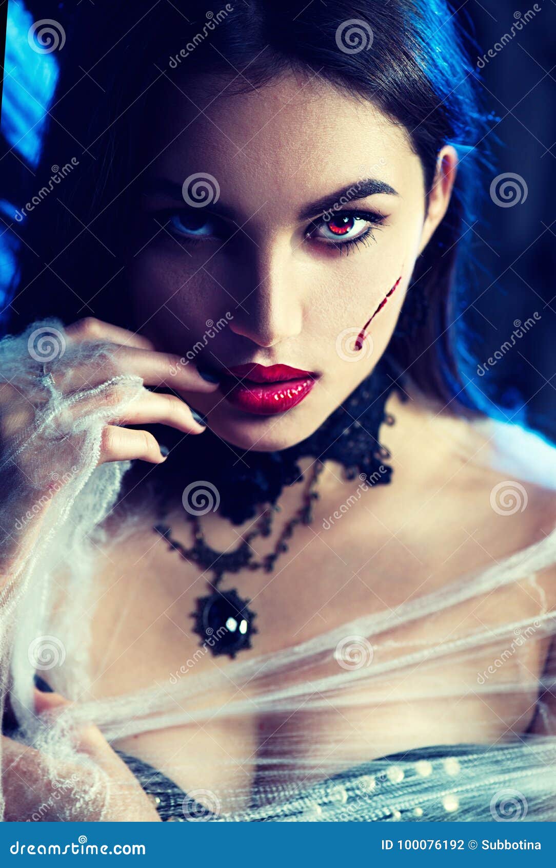 halloween. witch with a carved pumpkin and magic lightshalloween. beauty vampire woman posing in darkness