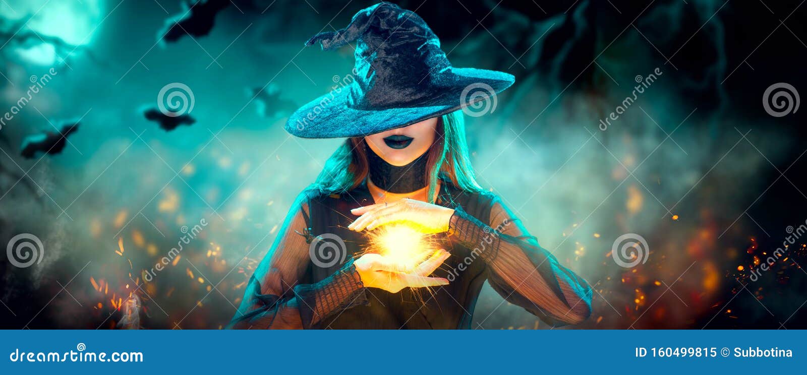 halloween witch girl with making witchcraft, magic in her hands, spells. beautiful young woman in witches hat conjuring