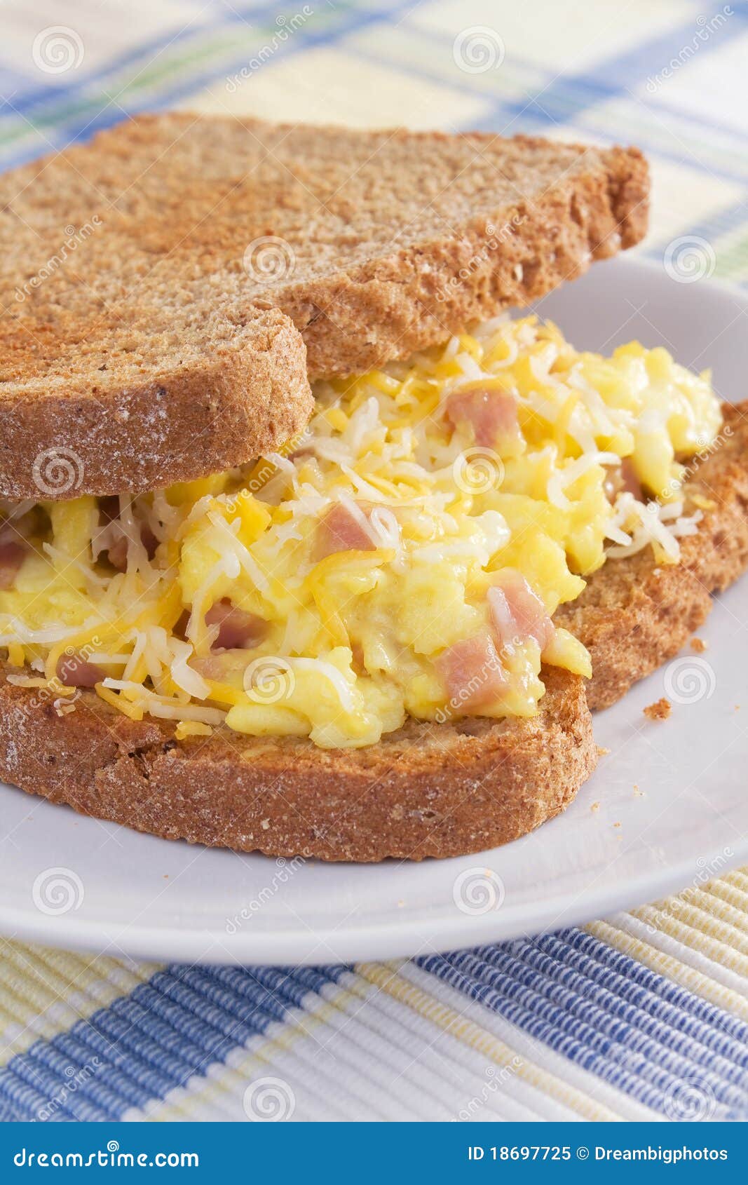 Ham Omelet Breakfast Sandwich. Ham, eggs, and cheese sandwiched between two slices of toasted wheat bread.