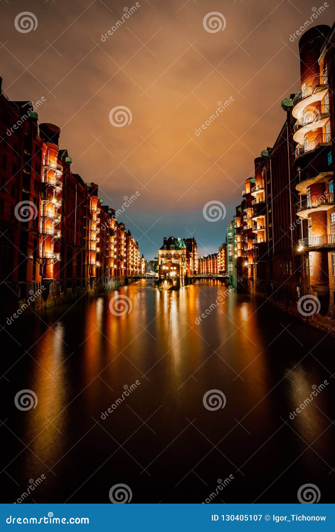 hamburg, germany. view of wandrahmsfleet at dusk illumination light with reflection in the water. located in warehouse