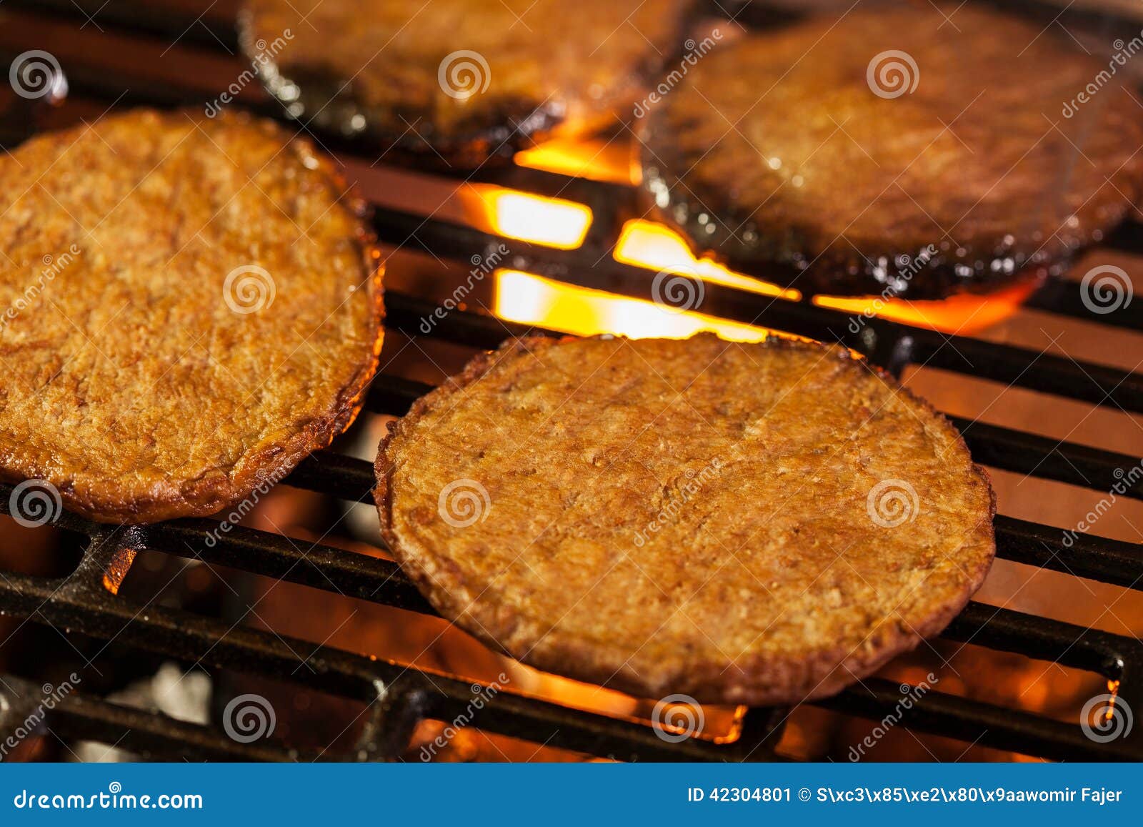 Hamburger Patties on a Grill with Fire Under Stock Image Image of