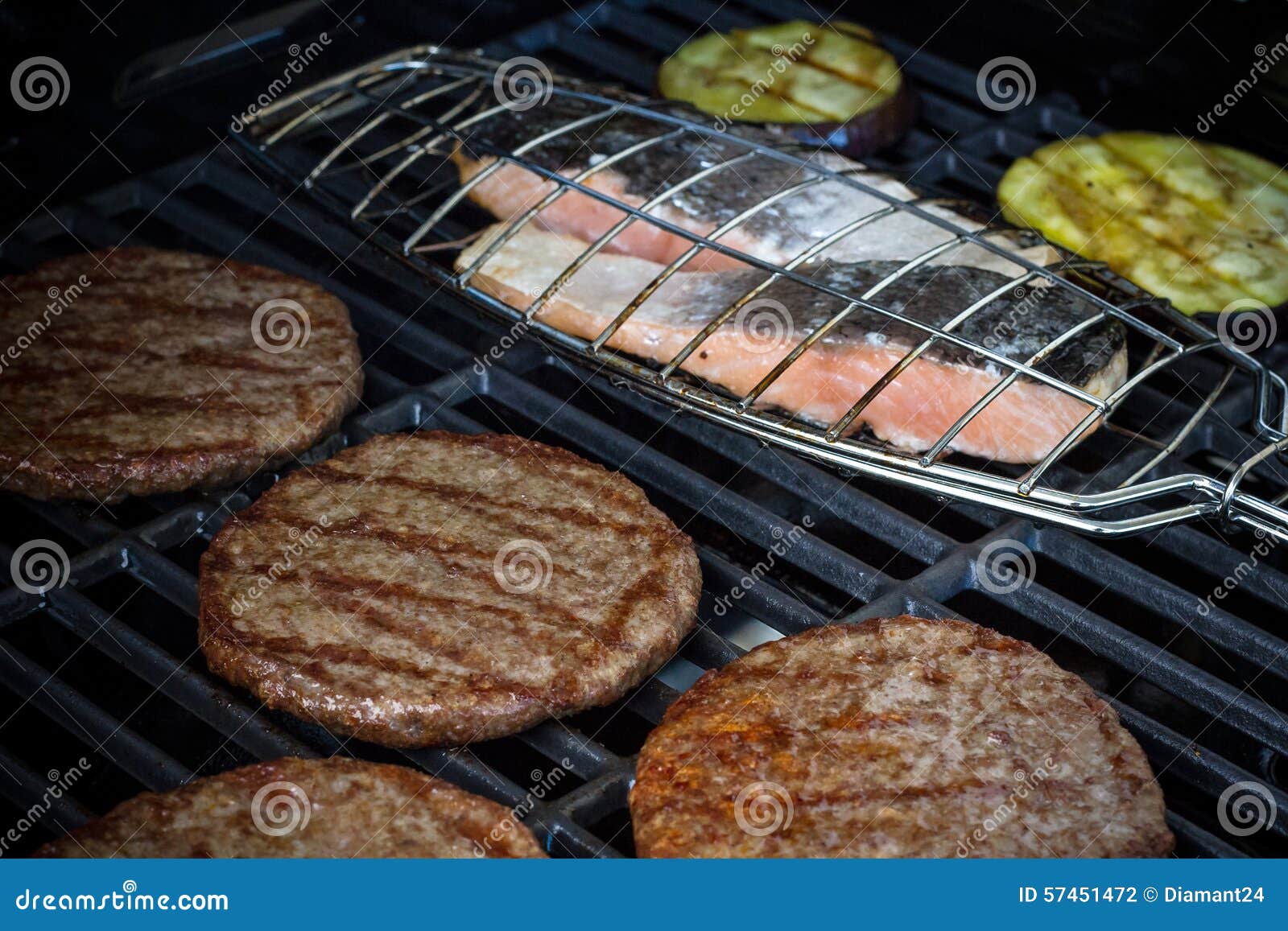 Hamburger Slices, Salmon Steak and Eggplant on Grill Rack Stock Photo