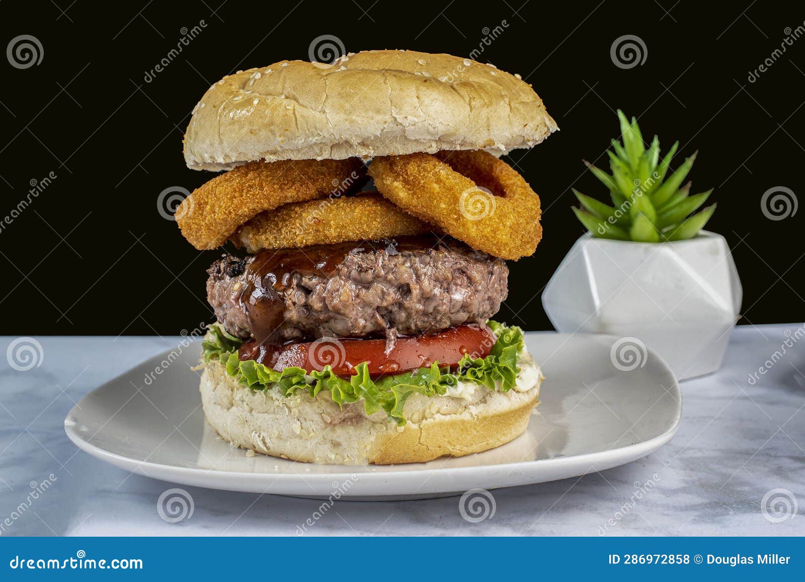 hamburger top with barbecue sauce and onion rings