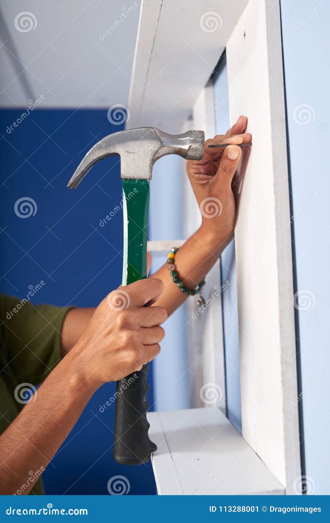 Hammering nail stock image. Image of apartment, female 113288001