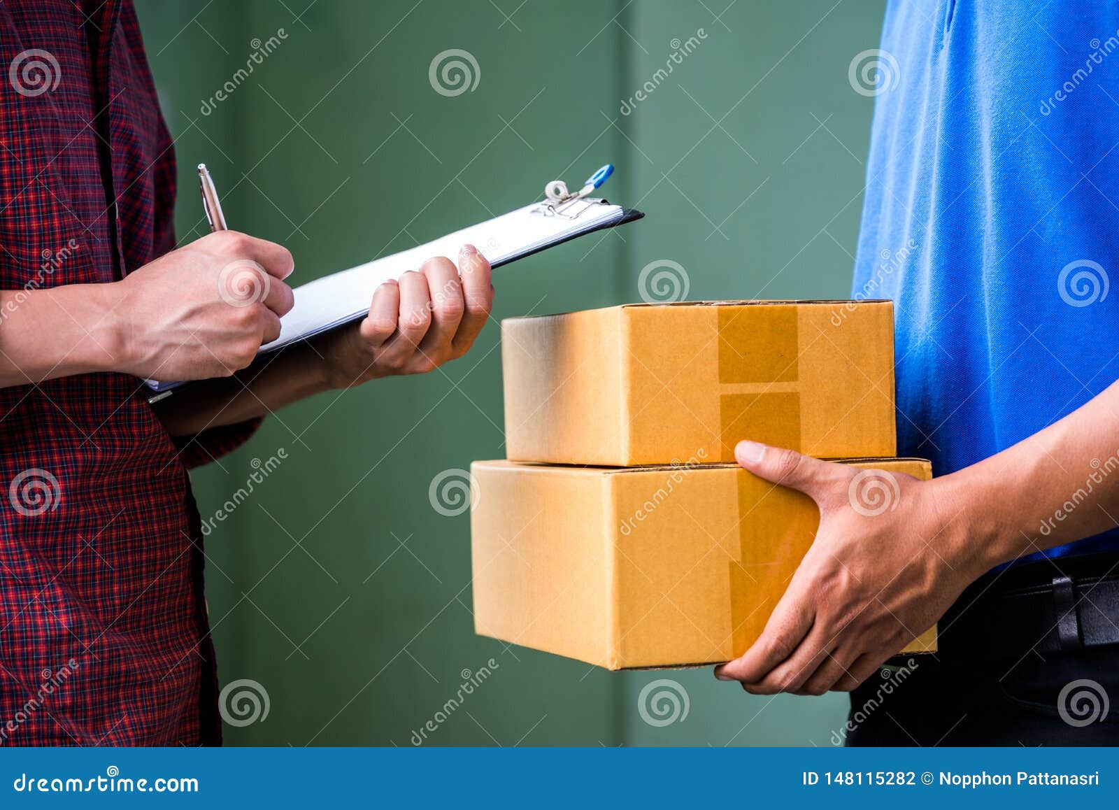 Male Hand Accepting a Delivery of Boxes from Deliveryman. Stock Photo