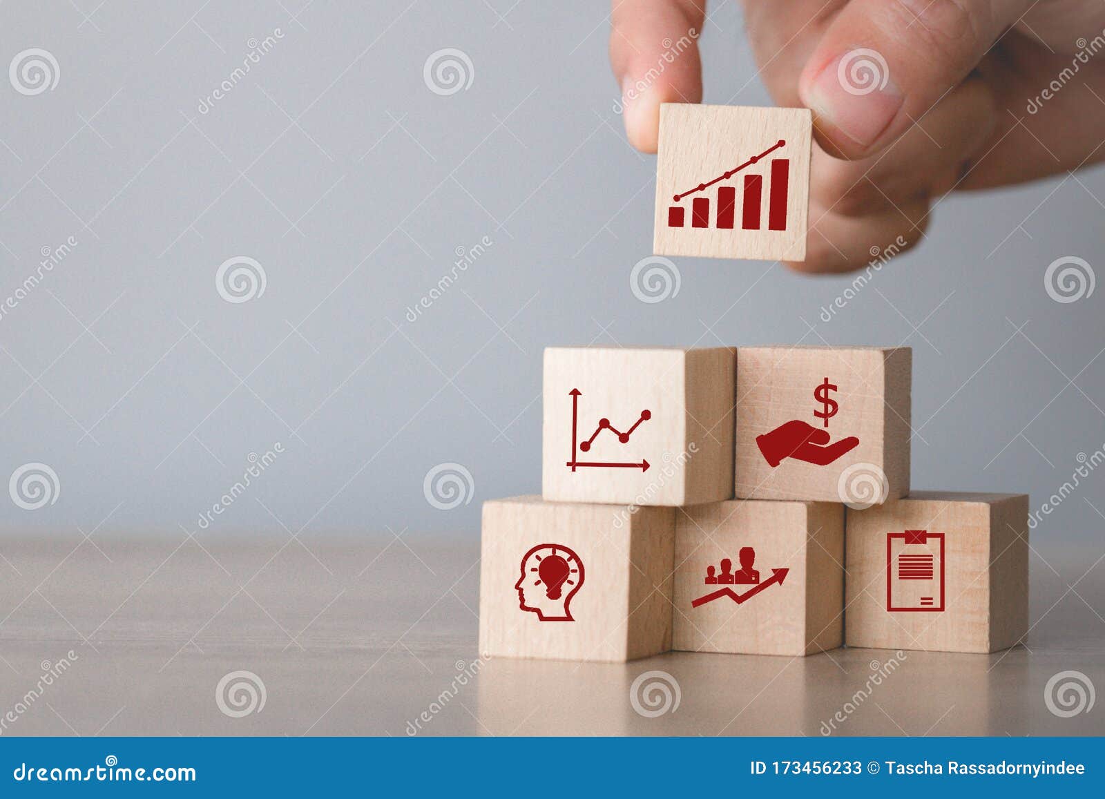 hand arranging wood block stacking with icon arrow and business,targeting the business .