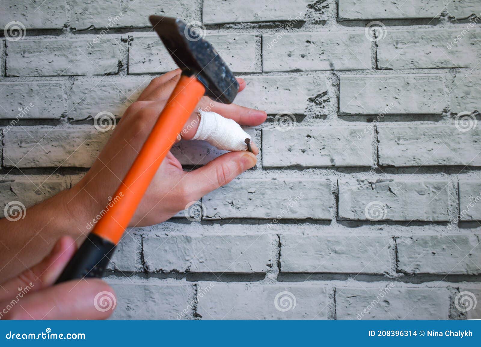 Hand with Bandaged Finger Drives Nail into the Wall, instead of Nail it  Hits Finger with Hammer. Man Drives Nail into Wall Stock Photo - Image of  finger, hand: 208396314