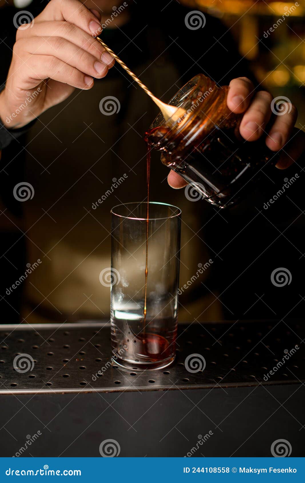 Hand of the Bartender Pours Syrup with a Spoon into a Transparent