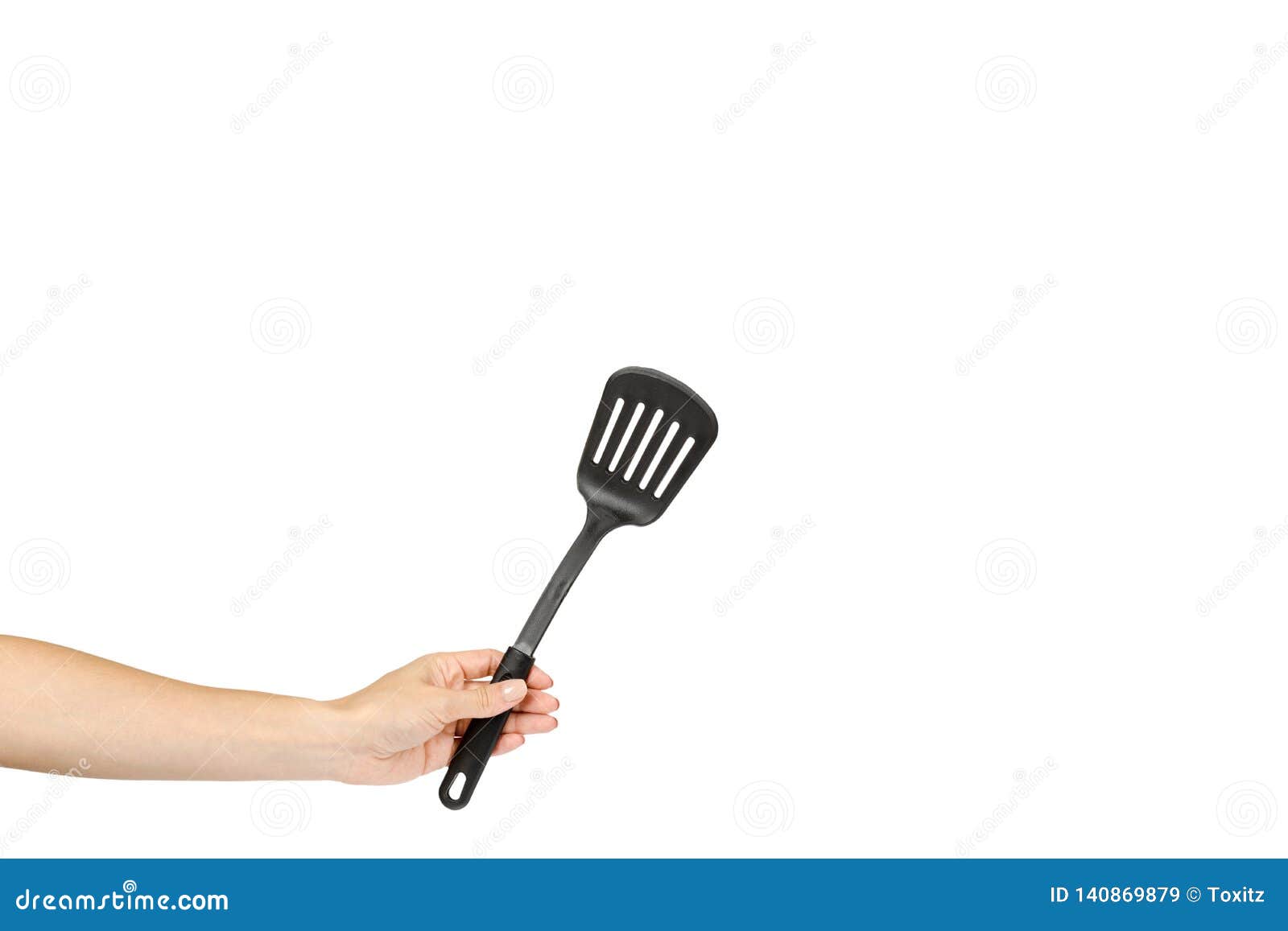 Hand with Black Plastic Kitchen Spatula, Kitchenware for Cooking Stock